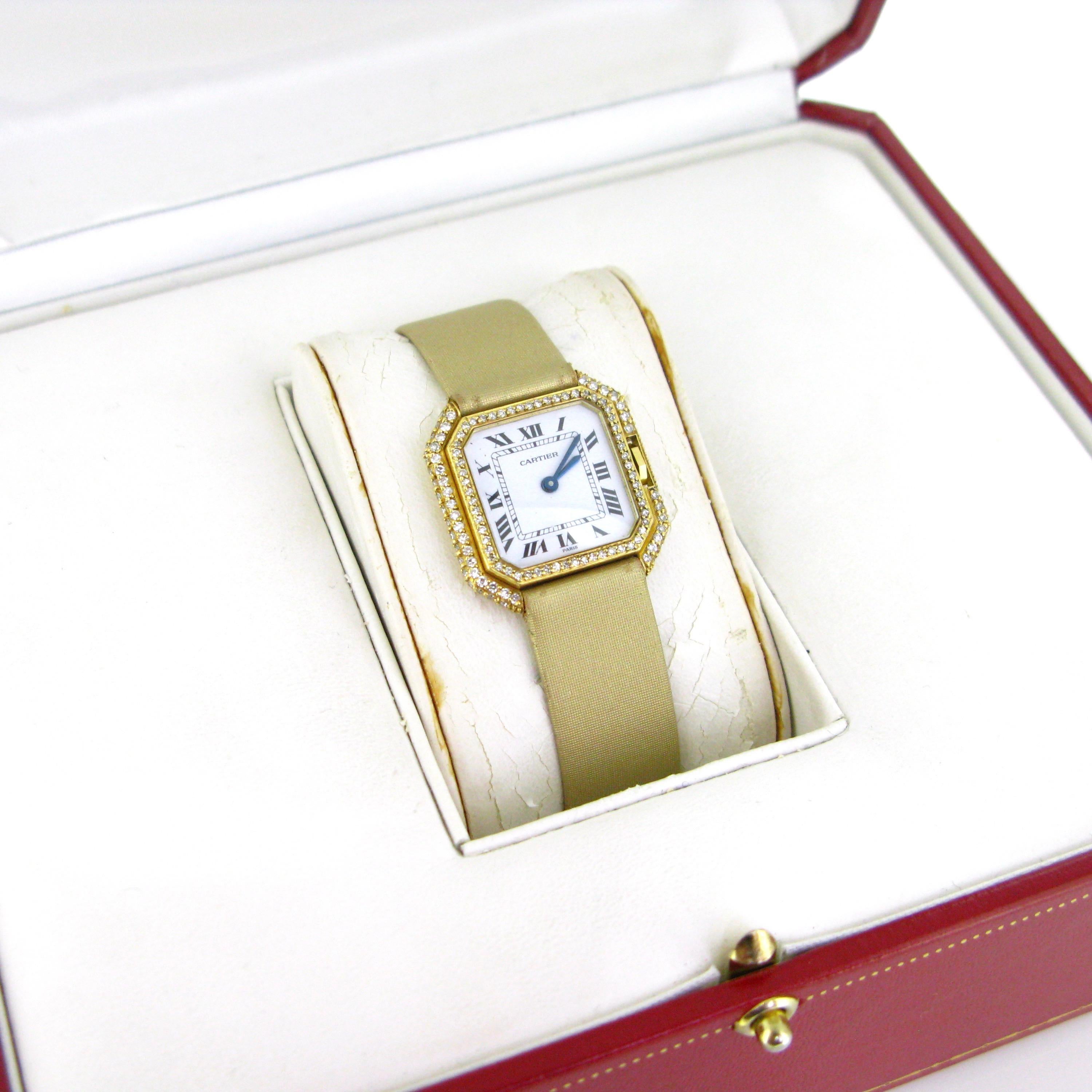 This Vintage Cartier wristwatch features an octagonal stepped case made in 18k yellow gold case with a mechanical hidden crown. The case is set with 3 rows of single cut diamonds for a total carat weight 1ct approximately with a color G/H and a VS