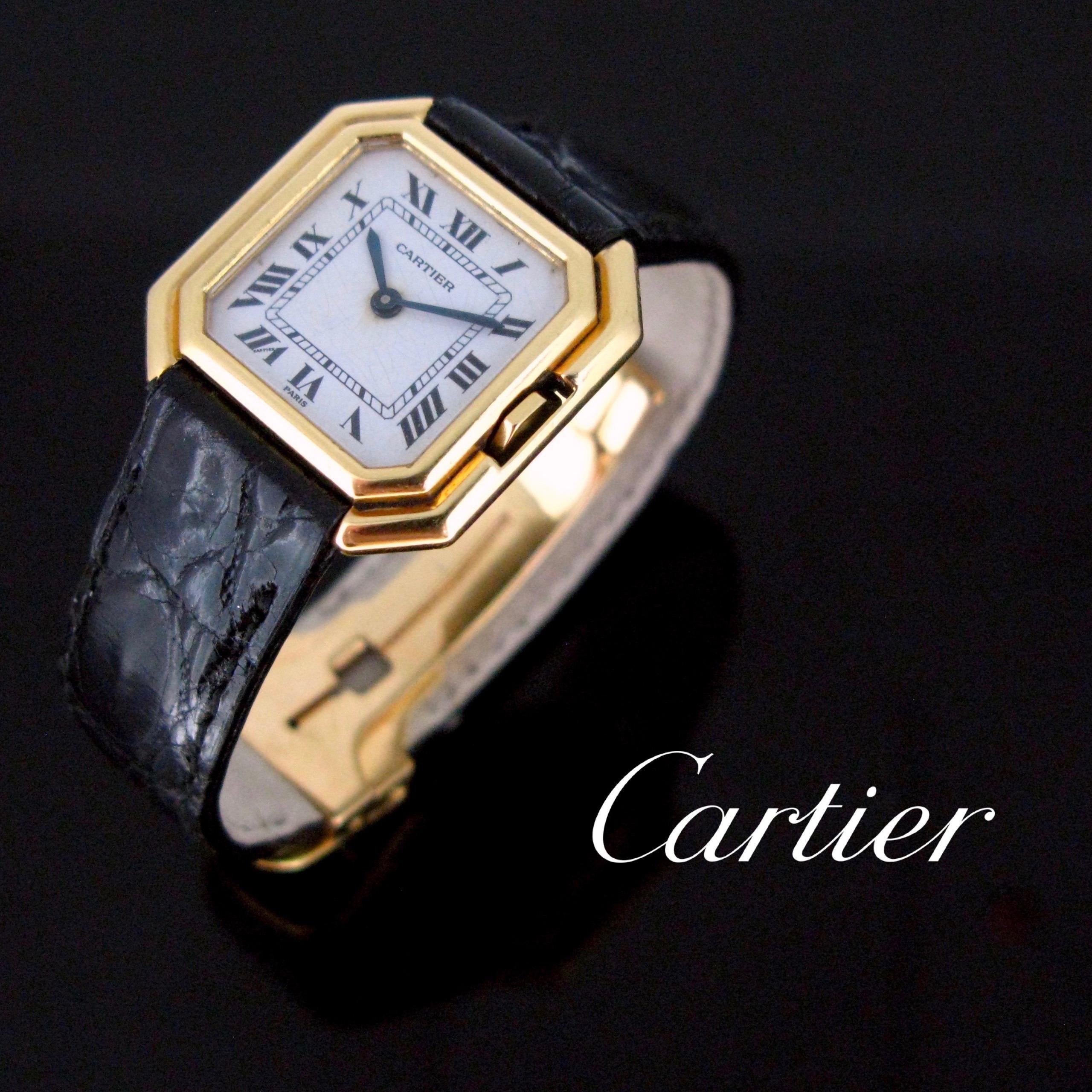 This Vintage Cartier wristwatch features an octagonal stepped case made in 18k gold case with a mechanical hidden crown. The Ceinture is set on a black leather deployment buckle. The model dates from the 70’s. It is in good