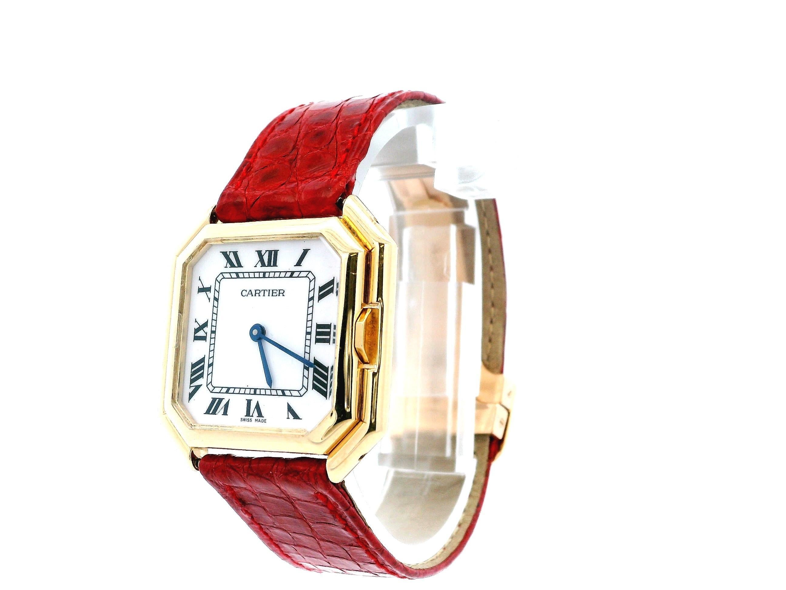 Cartier Ceinture Paris 1700 Watch. 31mm 18K yellow gold a case. 18K yellow gold bezel. White dial with blue hands and black Roman numeral hour marker. Minute markers on the inner dial. Red leather strap with 18K yellow gold deployment buckle. Will