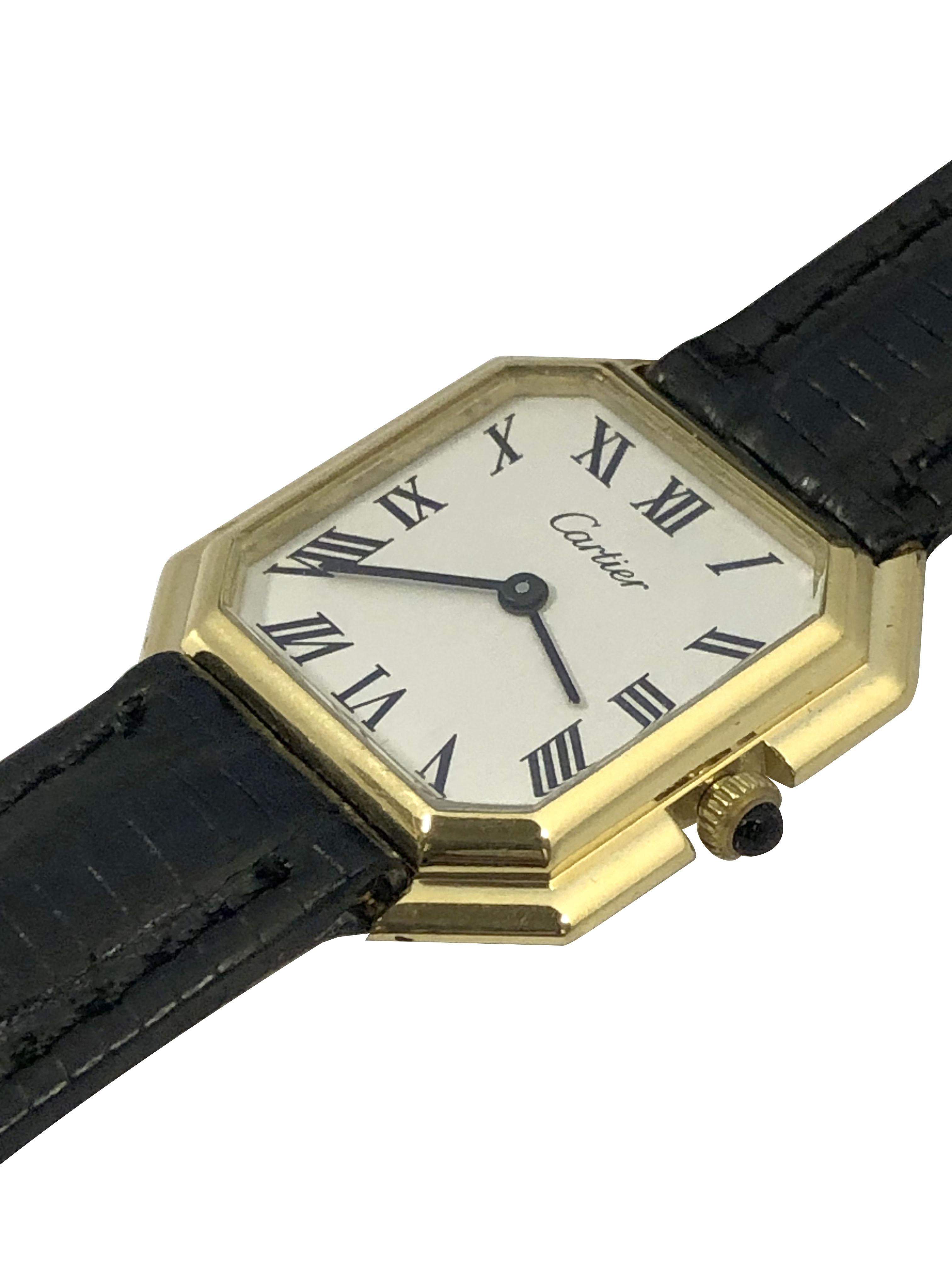 Circa 1970s Cartier Ceinture mid size Wrist Watch, 27 X 27 M.M 2 piece 18k Yellow Gold case. Cartier 17 Jewel mechanical, manual wind nickle lever movement. White dial with Black Roman numerals, Sapphire set crown. New Black Lizard strap, wrist size