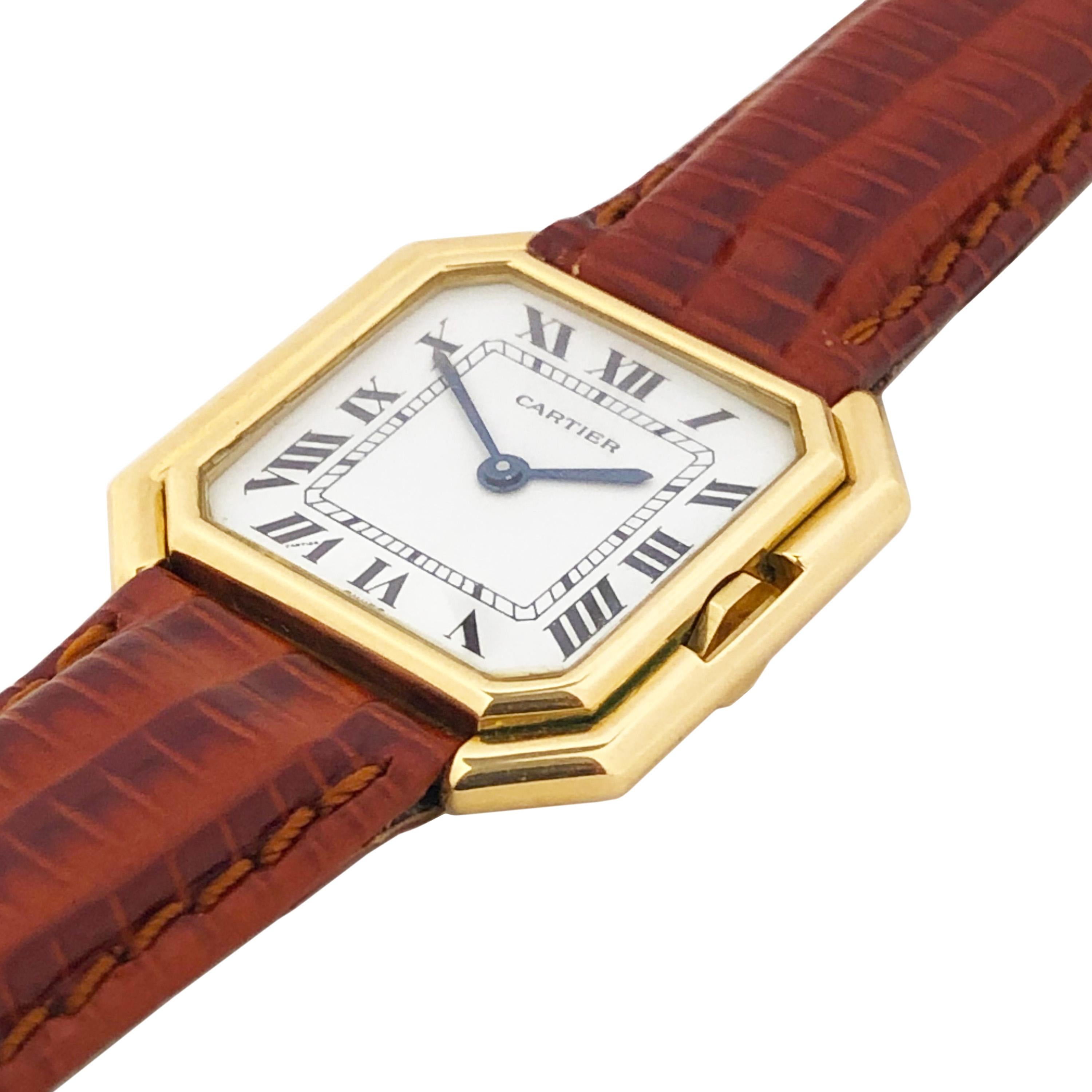 Circa 1970s Cartier Ceinture Wrist watch,  27 x 27 18K yellow Gold stepped case, 17 Jewel Mechanical, Manual wind movement.  White Dial with Black Roman Numerals. New Hirsch Brown Lizard Grain strap with Gold Plated Cartier Tang Buckle. Recently