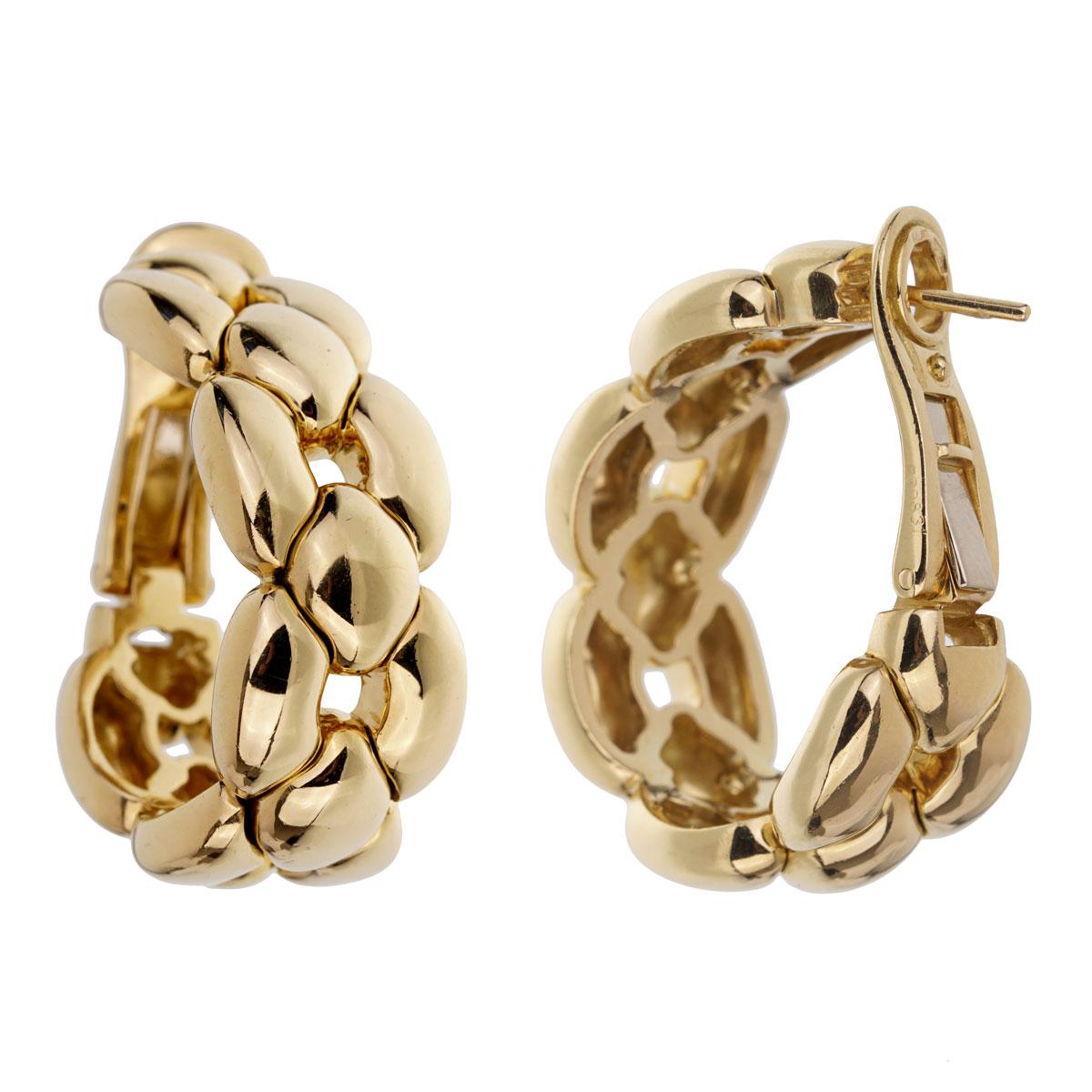 A magnificent pair of Cartier hoop earrings crafted in 18k yellow gold. The earrings measure .50