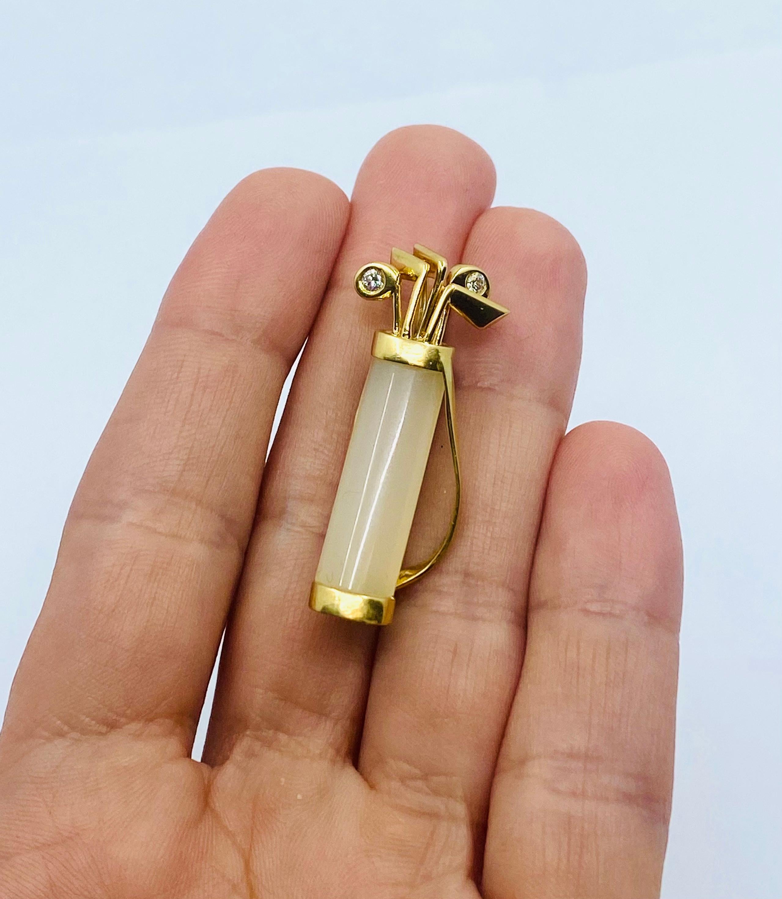 Designer: Cartier
Materials: 18 karat Yellow Gold
Weight:  9.8 grams
Gemstone:  Diamond
Gemstone: Chalcedony
Measurement: 1 1/2