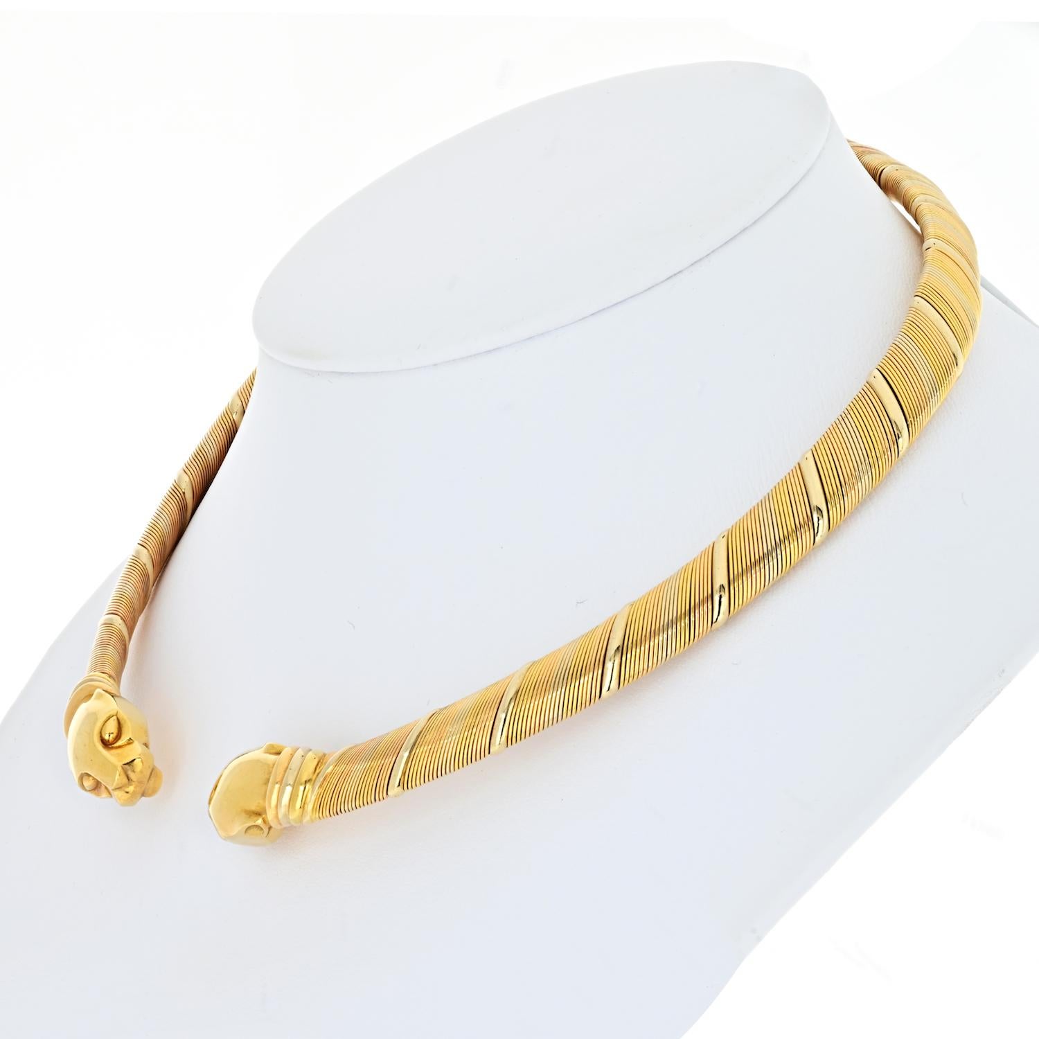 This stunning necklace is crafted of 18 karat pink, yellow, and white gold, and features two polished panther heads on each end of an elegantly curved tri-color coiled band. This is a chic necklace with the luxury and sophistication of