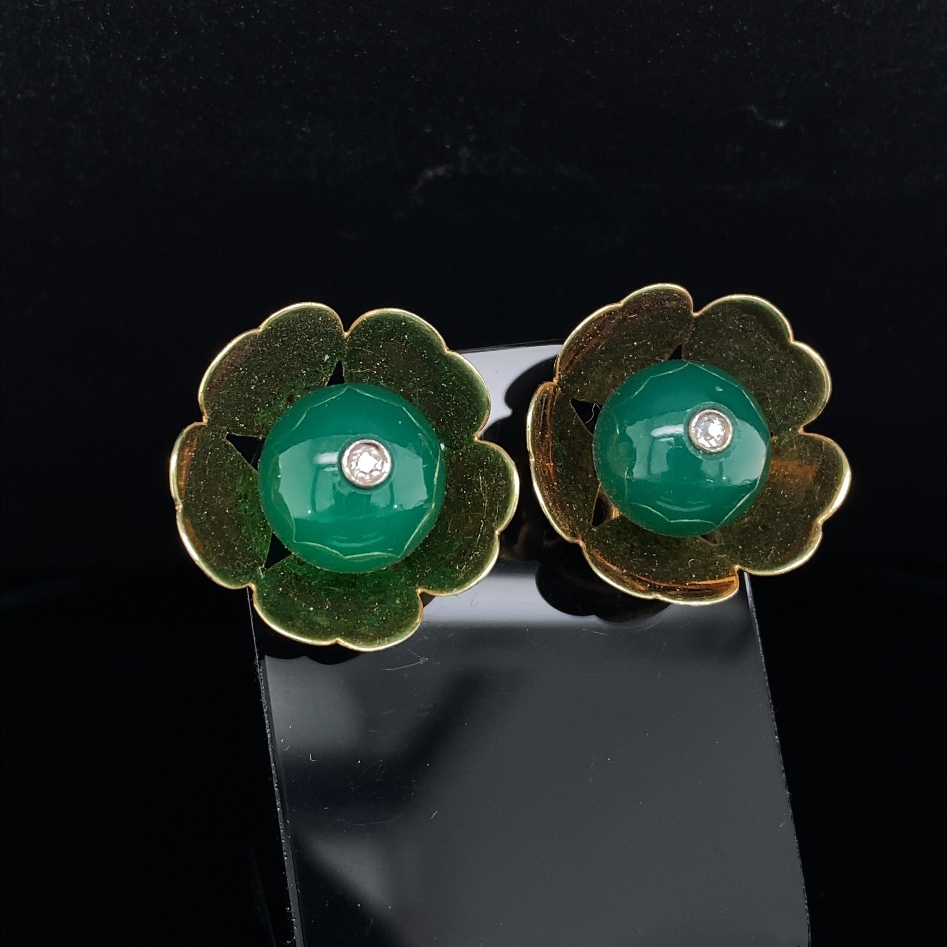 Cartier chrysophase and diamond floral earrings in 14 karat yellow gold.

These highly original and collectable vintage Cartier earrings are designed as flowers each set with a lively, round chrysophase bead dotted delicately in the centre with a