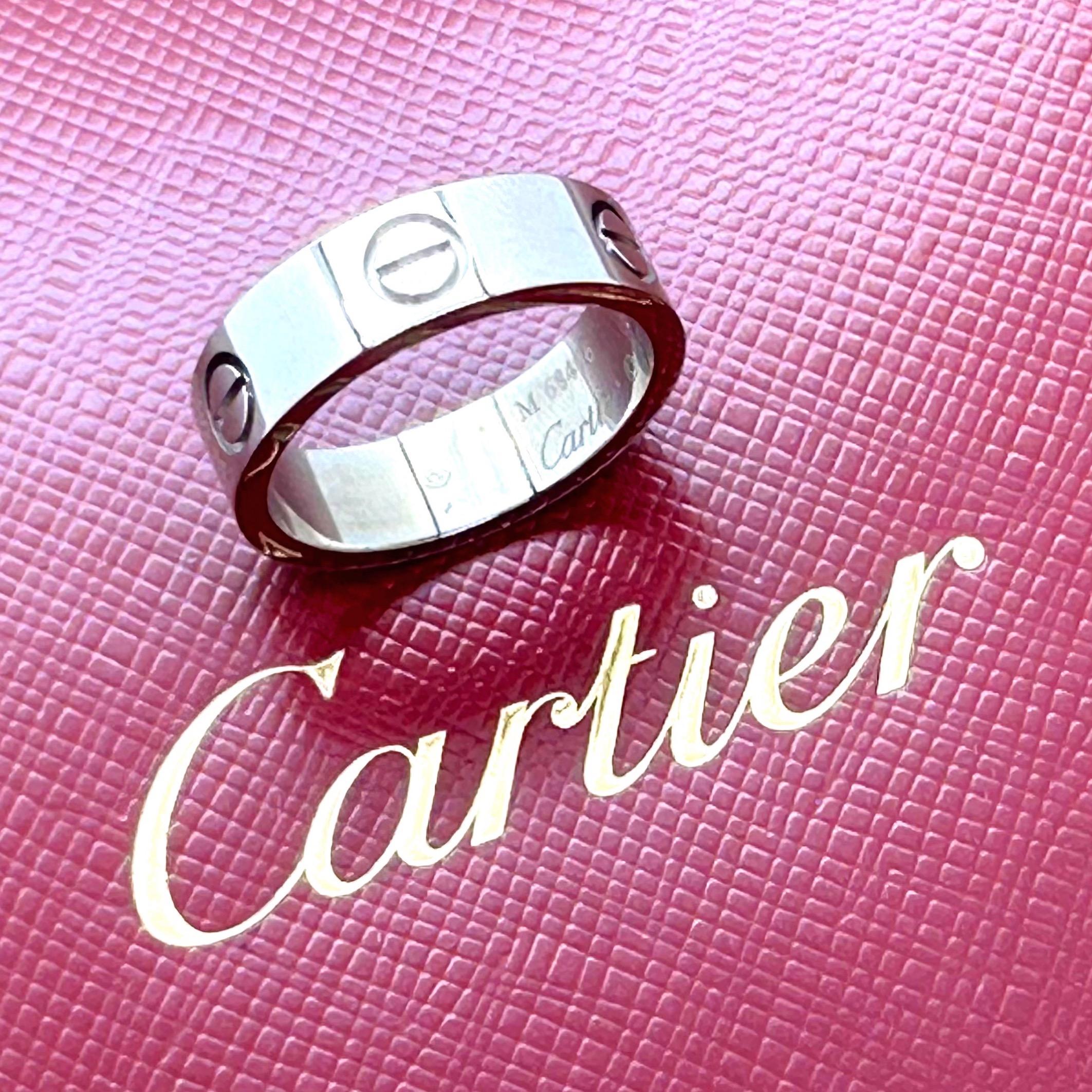 Cartier Circa 1996 Love Band Ring
Style:  Band
Ref. number:  M 68404
Metal:  18k White Gold
Size:  54 - 7 US
Measurements:  5 MM
Hallmark:  Cartier © 1996 750 M 68404 54
Includes:  Cartier Jewelry Pouch 
Sku#12010TGC02062024