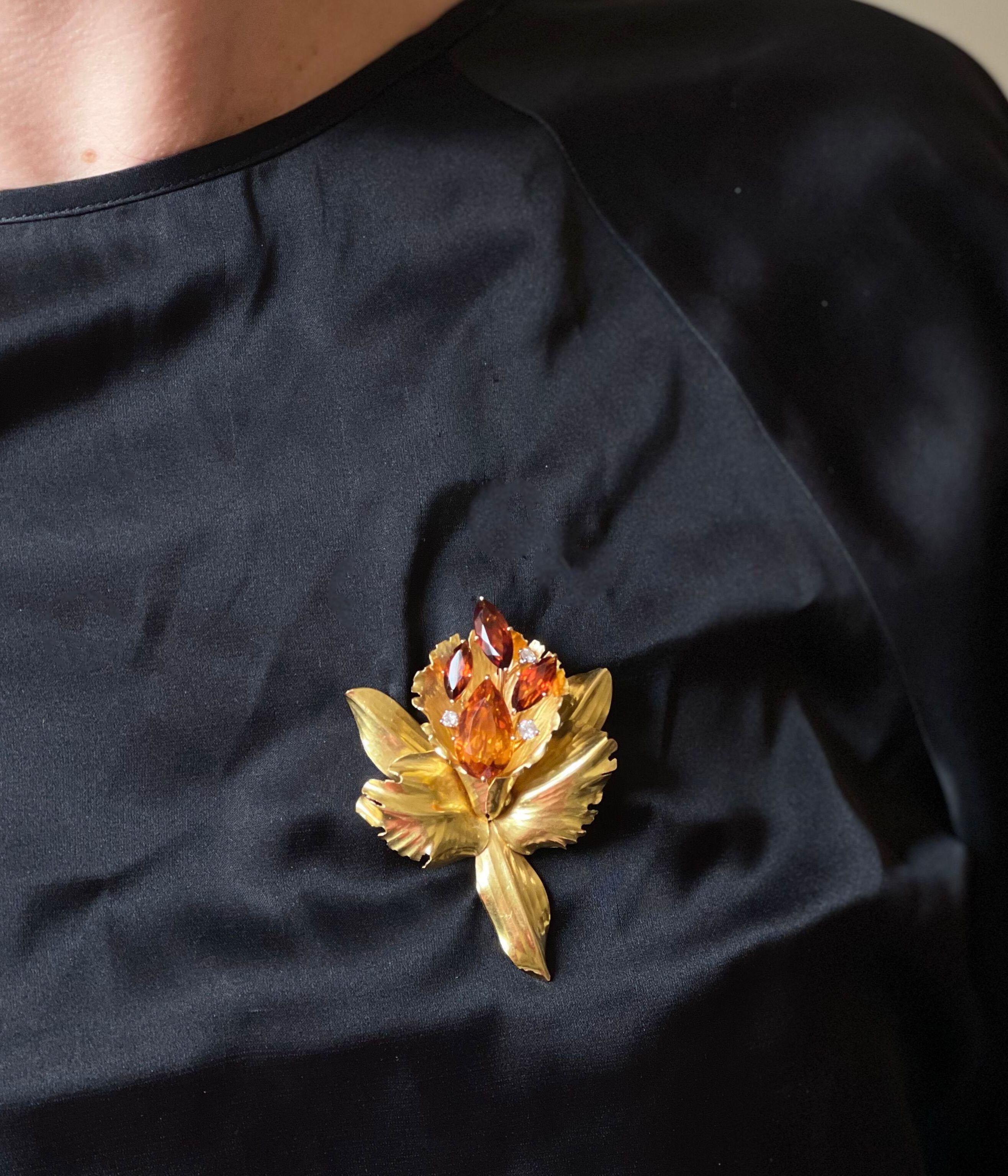 Large 18k gold orchid flower brooch by Cartier, with citrine and madeira citrine, surrounded with approx. 0.34ctw G/VS diamonds. Brooch measures 2 7/8