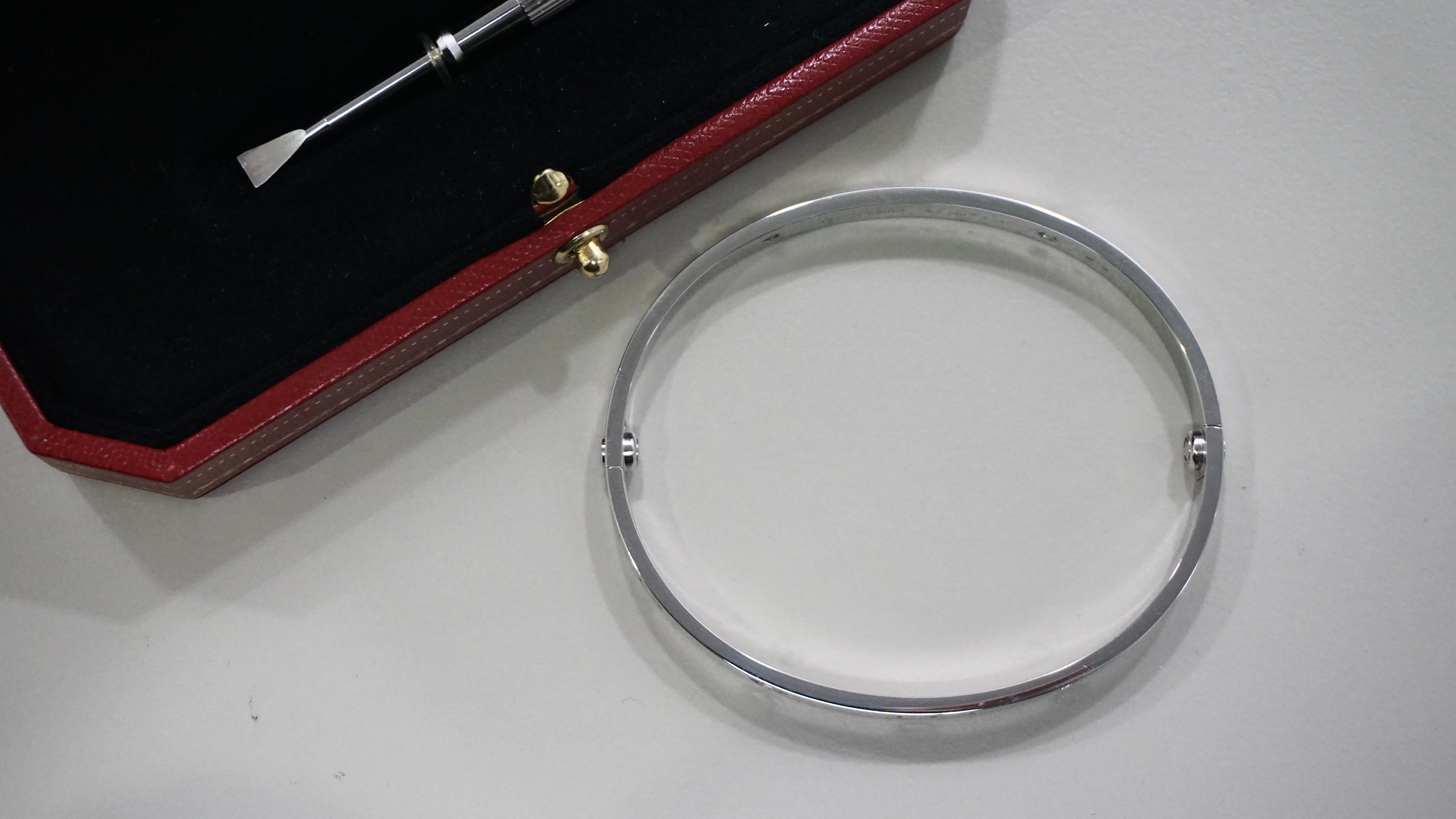 Cartier Love Bracelet Four Diamond Bangle in White Gold Size 19. Features 4 brilliant cut diamonds with a total carat weight of 0.42ct. Crafted in 18k white gold, it has a screw closure and is hallmarked. This bangle is signed and part of the