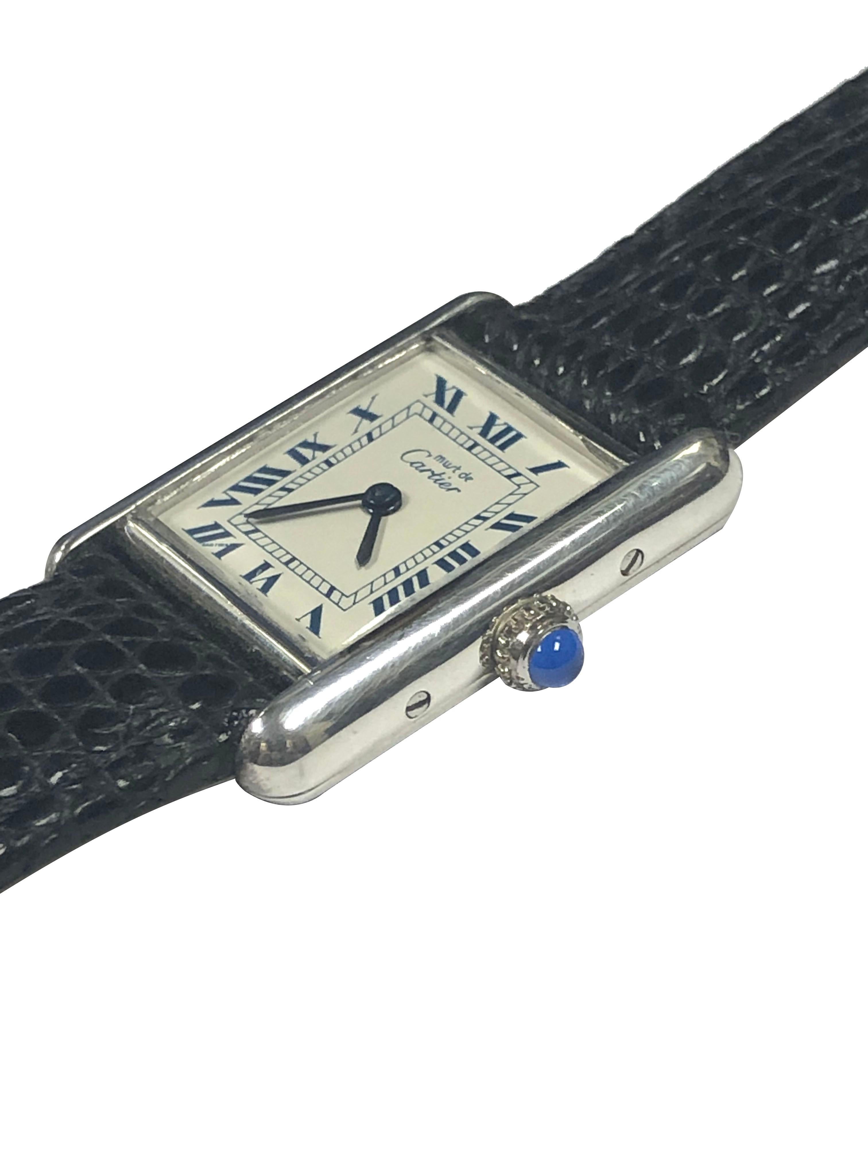 Circa 2000 Cartier classic Tank Wrist Watch, 19 X 20 M.M .925 Sterling Silver 2 piece case, Quartz movement, White dial with Blue Roman numerals, Sapphire Crown. New Black Lizard grain Leather Strap with Cartier Silver Plate Tang buckle. Comes in a