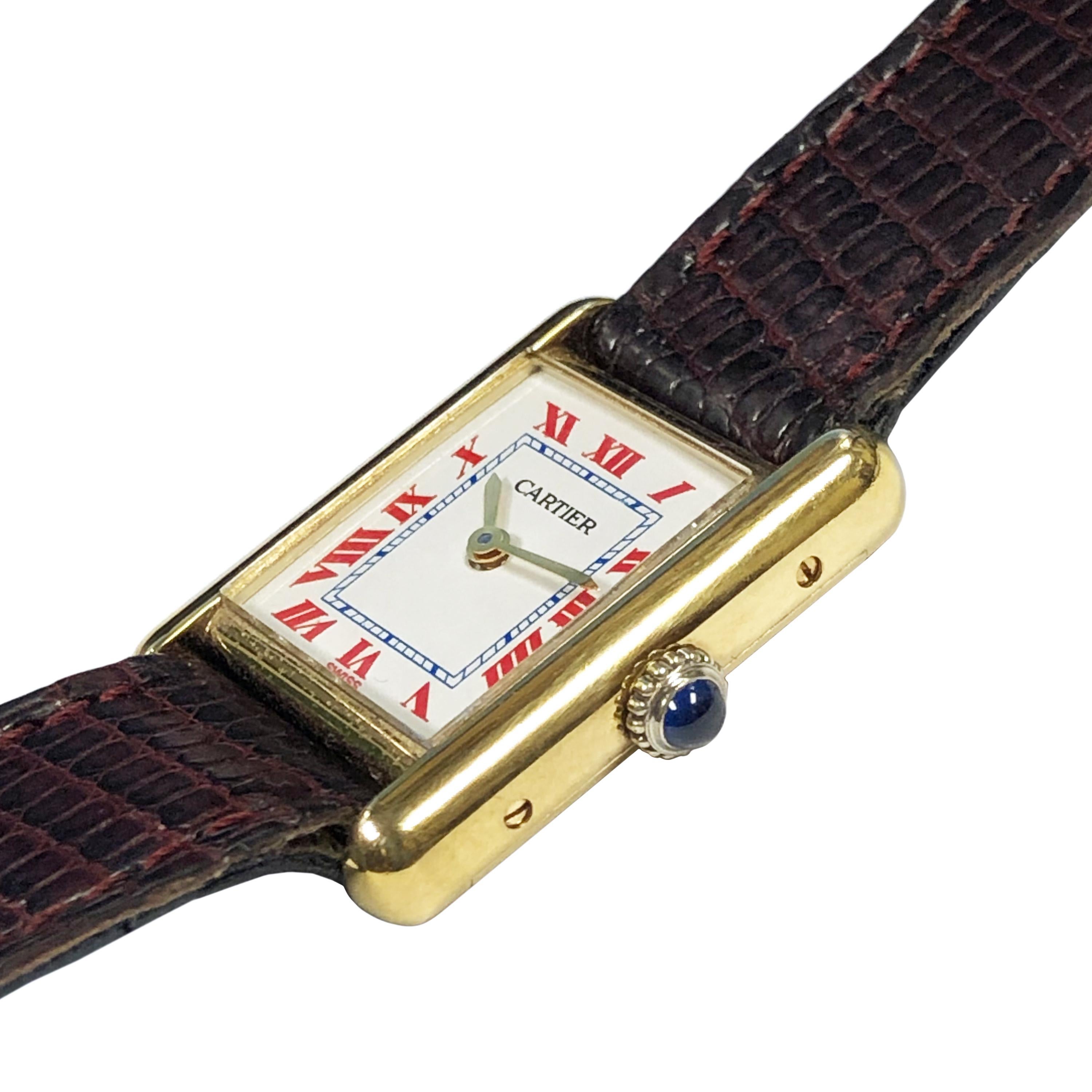 Circa 1990s Cartier Classic Ladies Tank Wrist Watch, 28 X 20 M.M. Vermeil ( Gold plate on Sterling Silver ) 2 piece case, 17 Jewel mechanical, manual wind movement and a Sapphire Crown. Custom White Dial with red Roman Numerals and a Blue inner
