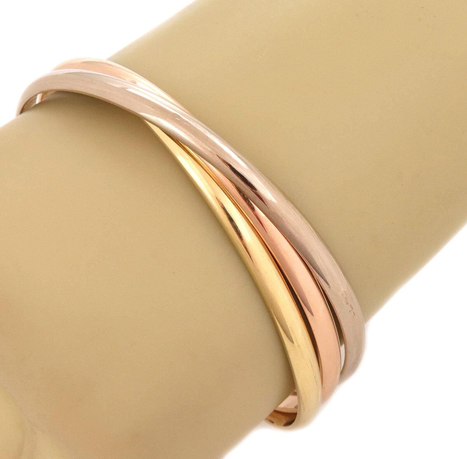 This gorgeous authentic triple interlaced bangles are by Cartier from the Trinity Collection. They are crafted from 18k pink, white and yellow gold respectively in a fine polished finish.  each bangle is 4.5mm wide with a dome shape. They are set in