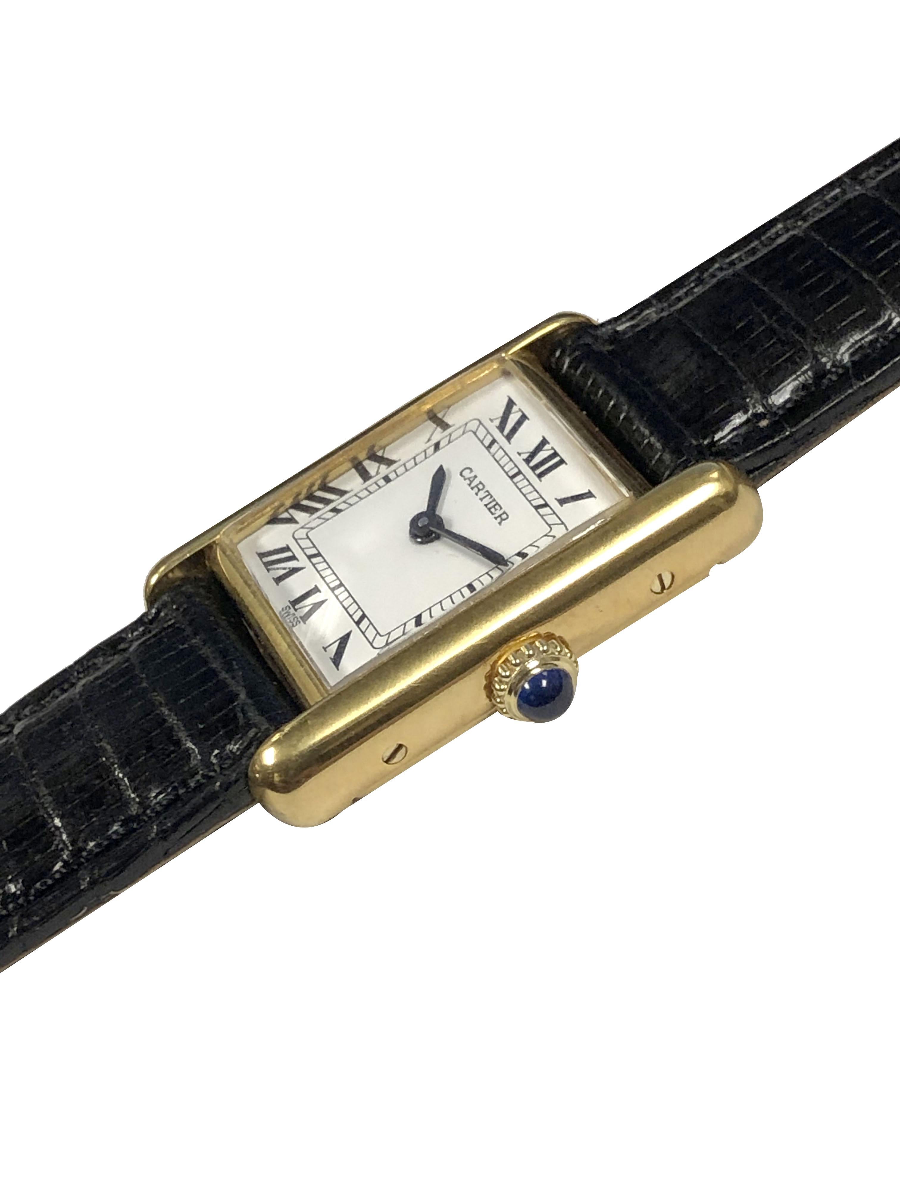 Circa 1990s Cartier classic Tank Wrist Watch, 28 X 20 M.M. 2 Piece Vermeil ( Gold plate on Sterling Silver ) case. Mechanical, manual wind movement, White Dial with Black Roman Numerals and a sapphire crown. New Black Lizard Strap with original