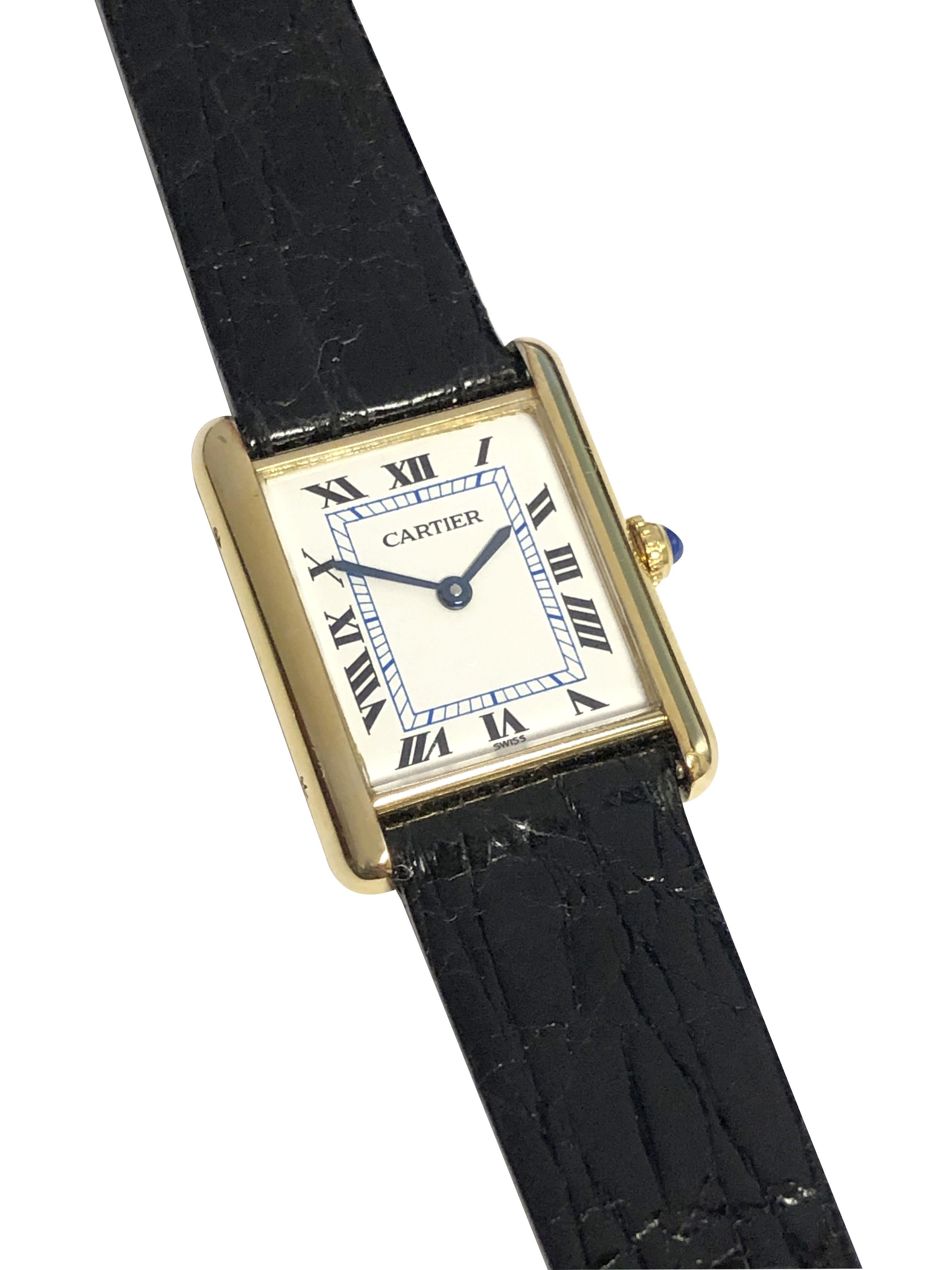 Circa 2000 Cartier Classic Tank Wrist Watch, 30 X 24 M.M. 2 Piece Vermeil ( Gold plate on Sterling Silver ) case. Quartz Movement, Sapphire Crown, White Dial with Black Roman Numerals and Blue inner Track. New Black Crocodile strap with original