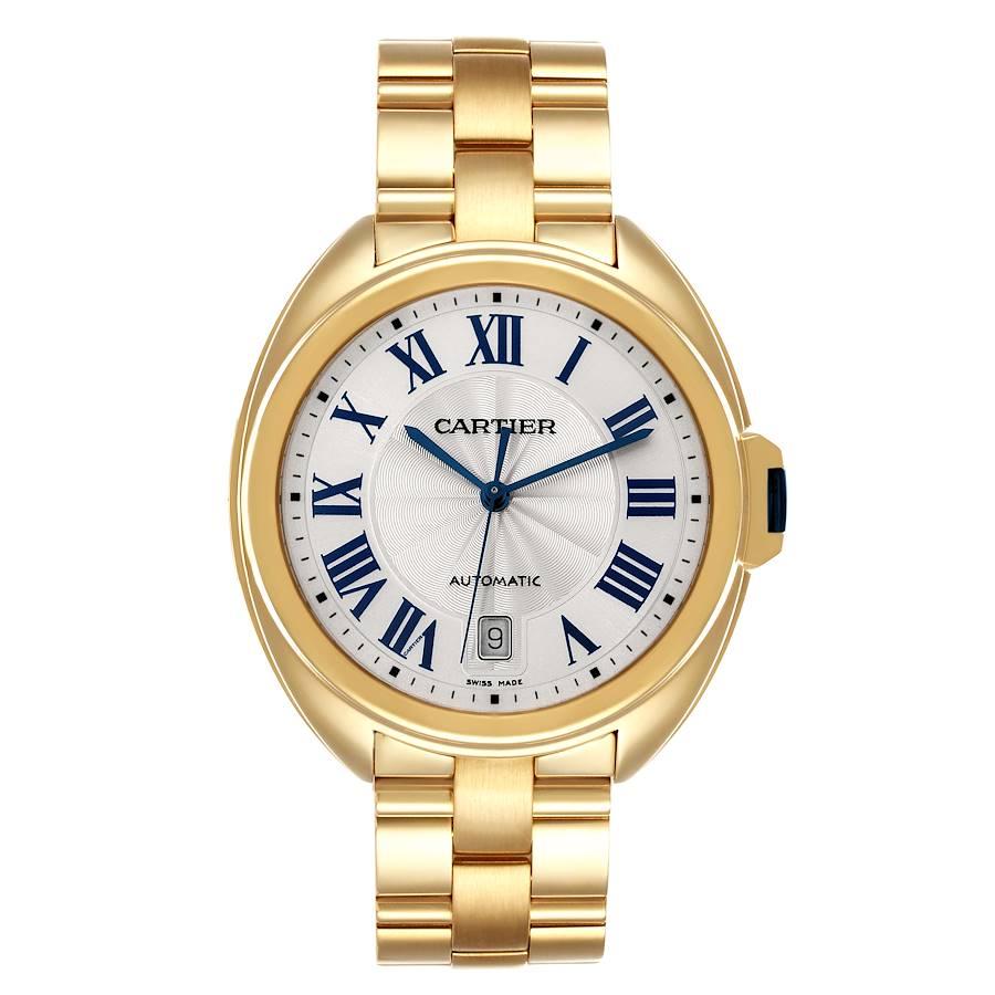 Cartier Cle 18K Yellow Gold Automatic Silver Dial Mens Watch WGCL0003. Automatic self-winding movement. Round 18K yellow gold case 40 mm in diameter. Flush-mounted crown set with the blue sapphire cabochon. 18K yellow gold bezel. Scratch resistant