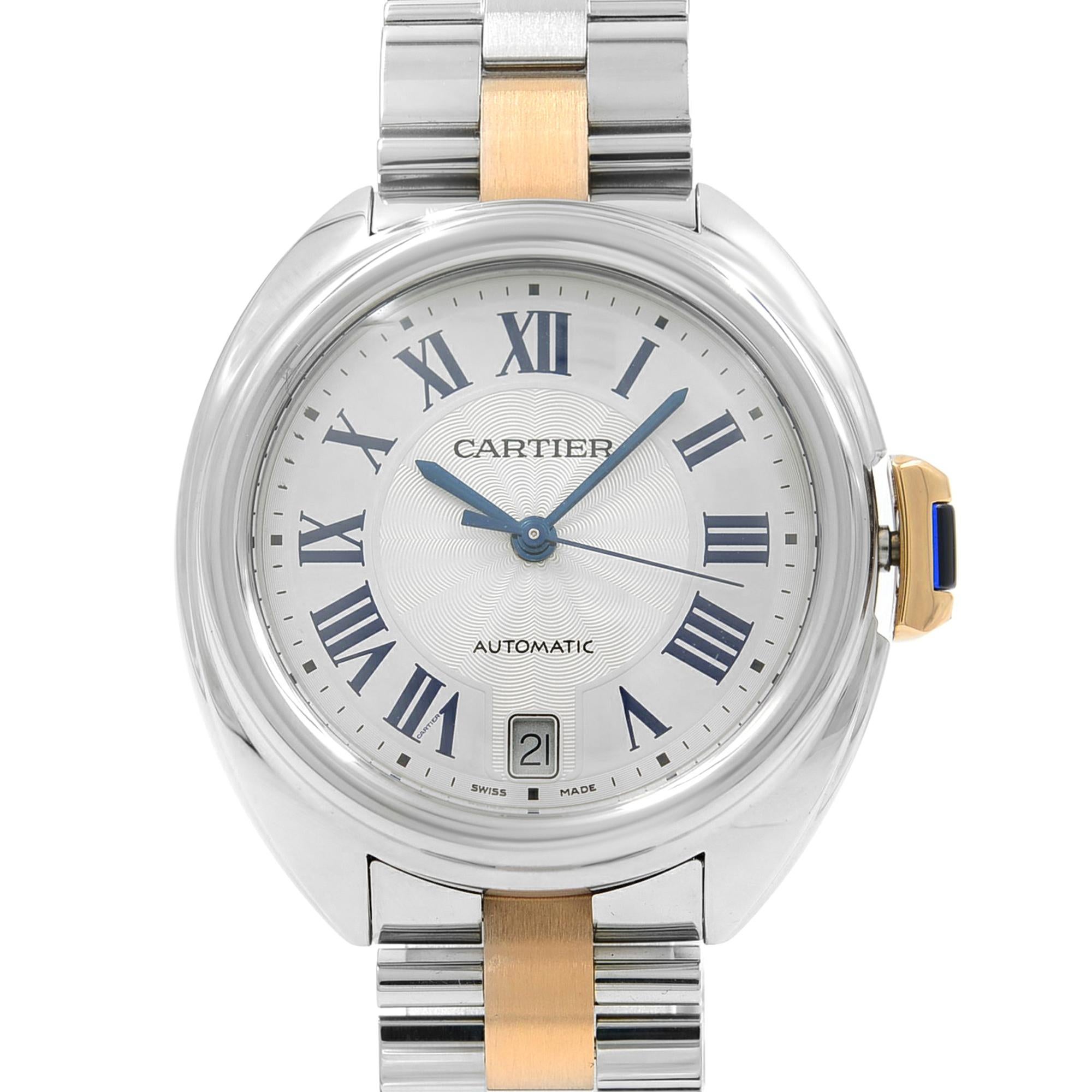 This  never been worn  Cartier Cle De Cartier W2CL0003 is a beautiful Ladie's timepiece that is powered by mechanical (automatic) movement which is cased in a stainless steel case. It has a round shape face, date indicator dial and has hand roman