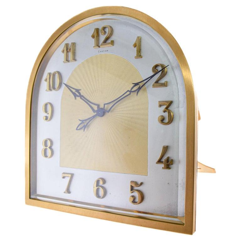 FACTORY / HOUSE: European Clock & Watch Co. / Cartier
STYLE / REFERENCE: Art Deco Chiming Clock 
METAL / MATERIAL: Gilt Brass and Bronze with Beveled Glass Lens
CIRCA / YEAR: 1930's
DIMENSIONS / SIZE: Tall 8.5 Inches X 7.5 Wide 4 Inches