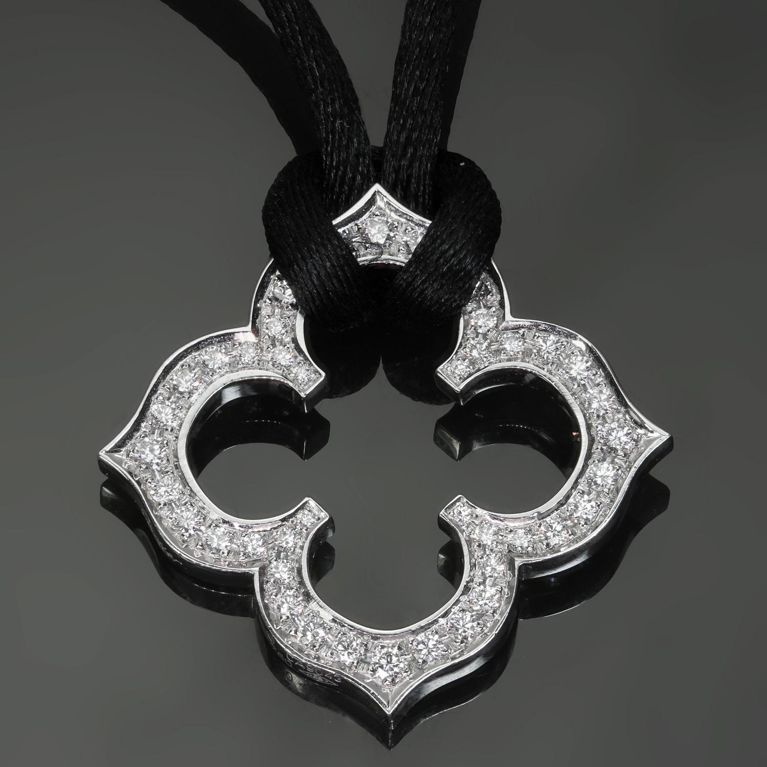 This fantastic Cartier pendant features a classic clover design crafted in 18k white gold and set with brilliant-cut round D-F VVS1-VVS2 diamonds and completed with a black silk cord. Made in France circa 2000s. Measurements: 1.18
