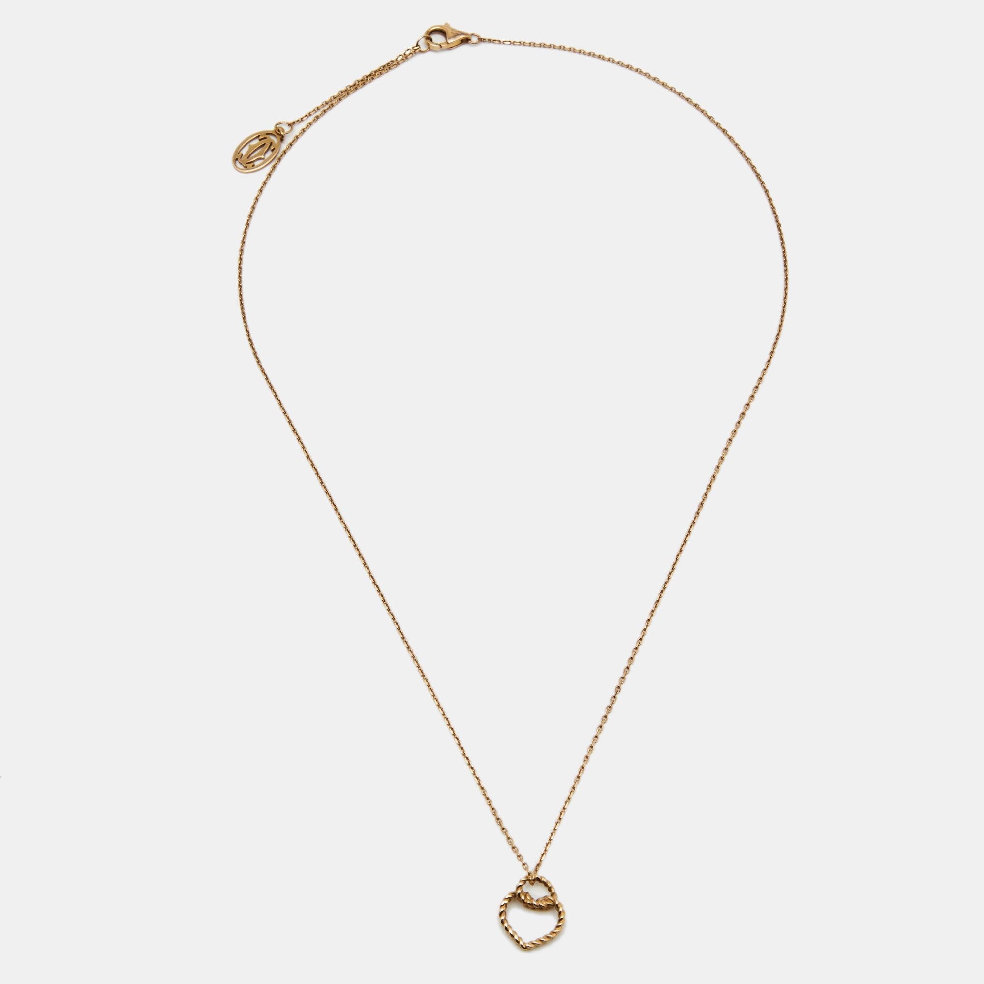 This Coeur Torsadé De Cartier necklace is a fine piece to wear solo or for layering with other neckpieces. The necklace is crafted from 18k rose gold, and the simple chain holds a twisted heart pendant.

