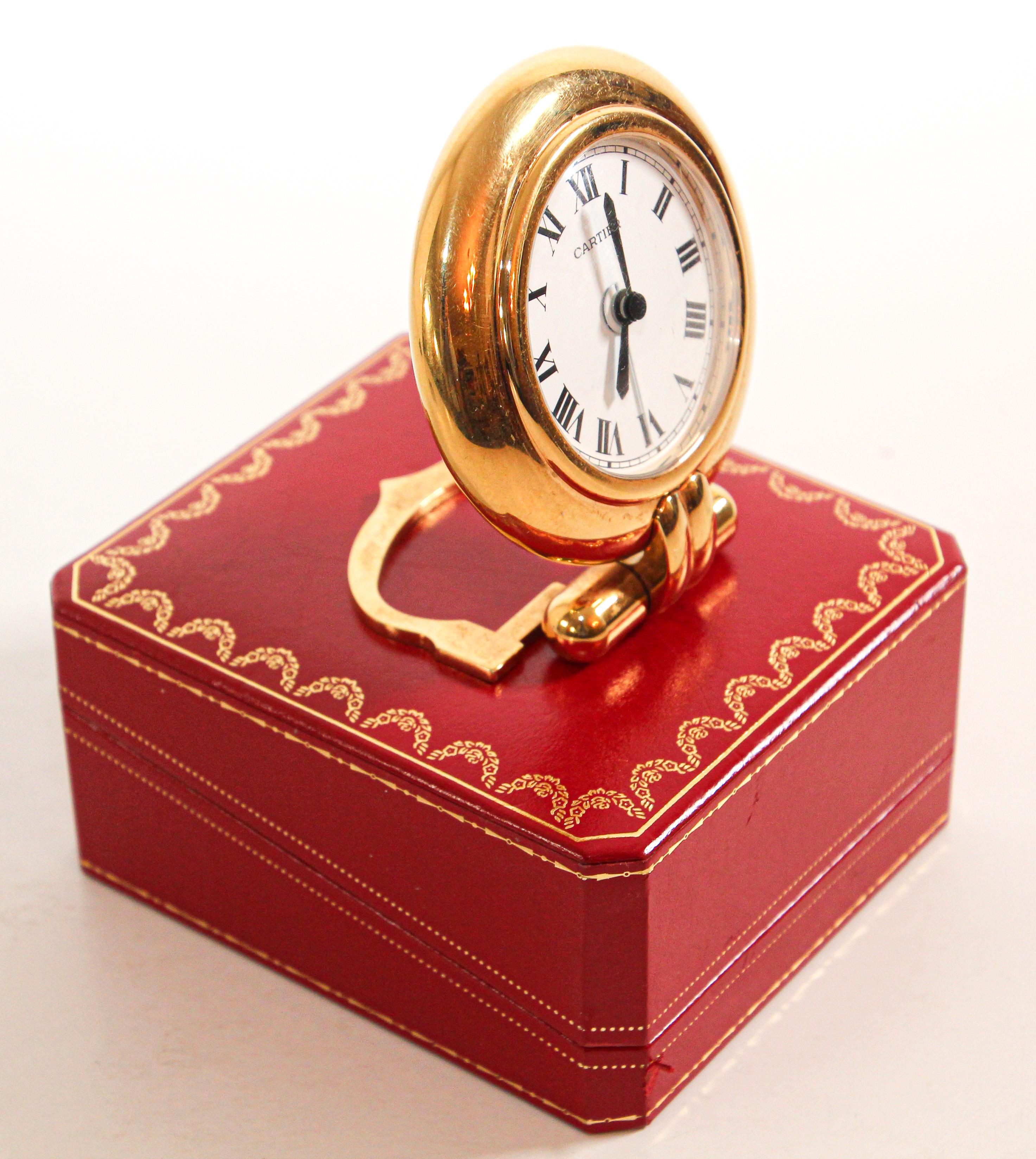 Vintage Cartier 24-karat gold-plated Art Deco travel quartz desk clock with alarm.
Cartier 24-karat gold-plated and lapis lazuli quartz travel or desk accessory clock is no longer being made.
It is vintage from the 1990s. It was originally