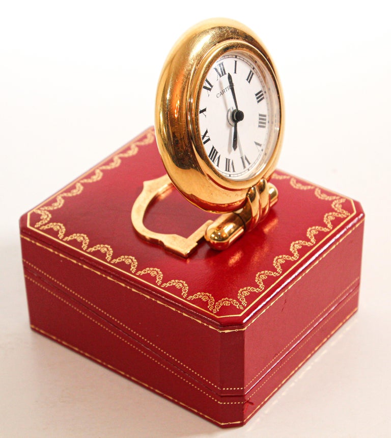 Vintage Cartier 24-karat gold-plated Art Deco travel quartz desk clock with alarm.
Cartier 24-karat gold-plated and lapis lazuli quartz travel or desk accessory clock is no longer being made.
It is vintage from the 1990s. It was originally