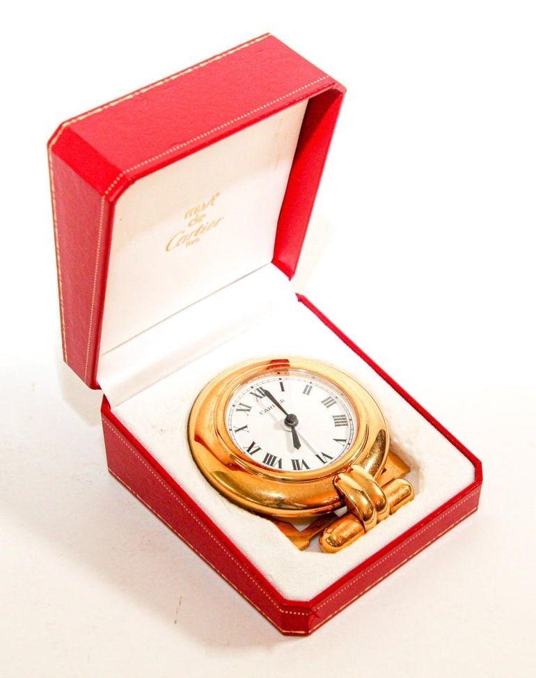 Vintage Cartier 24-karat gold-plated Art Deco travel quartz desk clock with alarm.
Cartier 24-karat gold-plated and lapis lazuli quartz travel or desk accessory clock is no longer being made.
It is vintage from the 1990s. It was originally designed