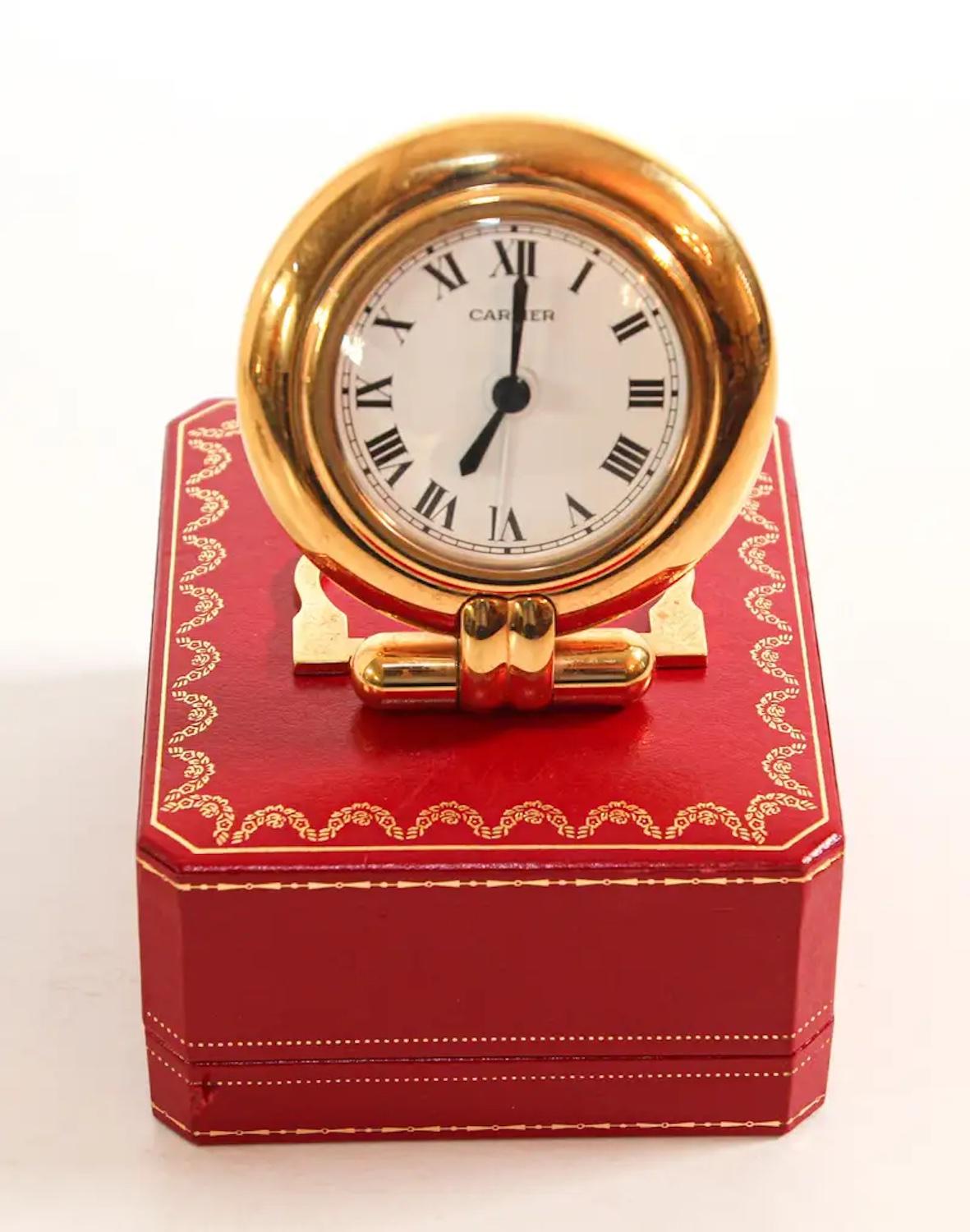 Vintage Cartier 24-karat gold-plated Art Deco travel quartz desk clock with alarm.
Cartier 24-karat gold-plated and lapis lazuli quartz travel or desk accessory clock is no longer being made.
It is vintage from the 1990s. It was originally designed