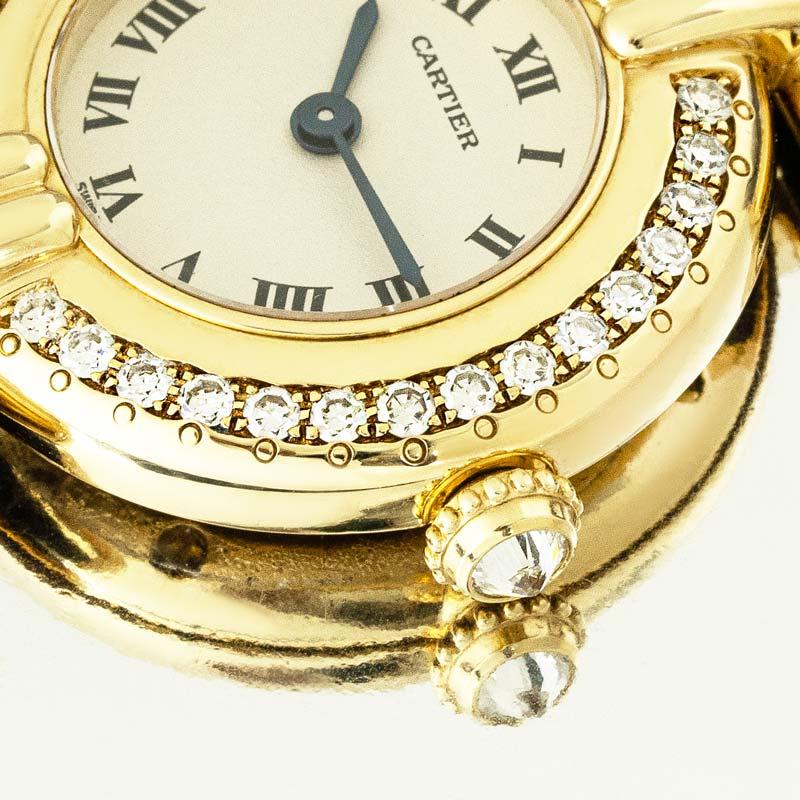 A yellow gold Colisee wristwatch by Cartier. Features a silver dial with Roman numerals, sword-shaped hands in blued steel, and a secret Cartier signature at X. Complementing the dial is the bezel and lugs set with a total of 42 round brilliant cut