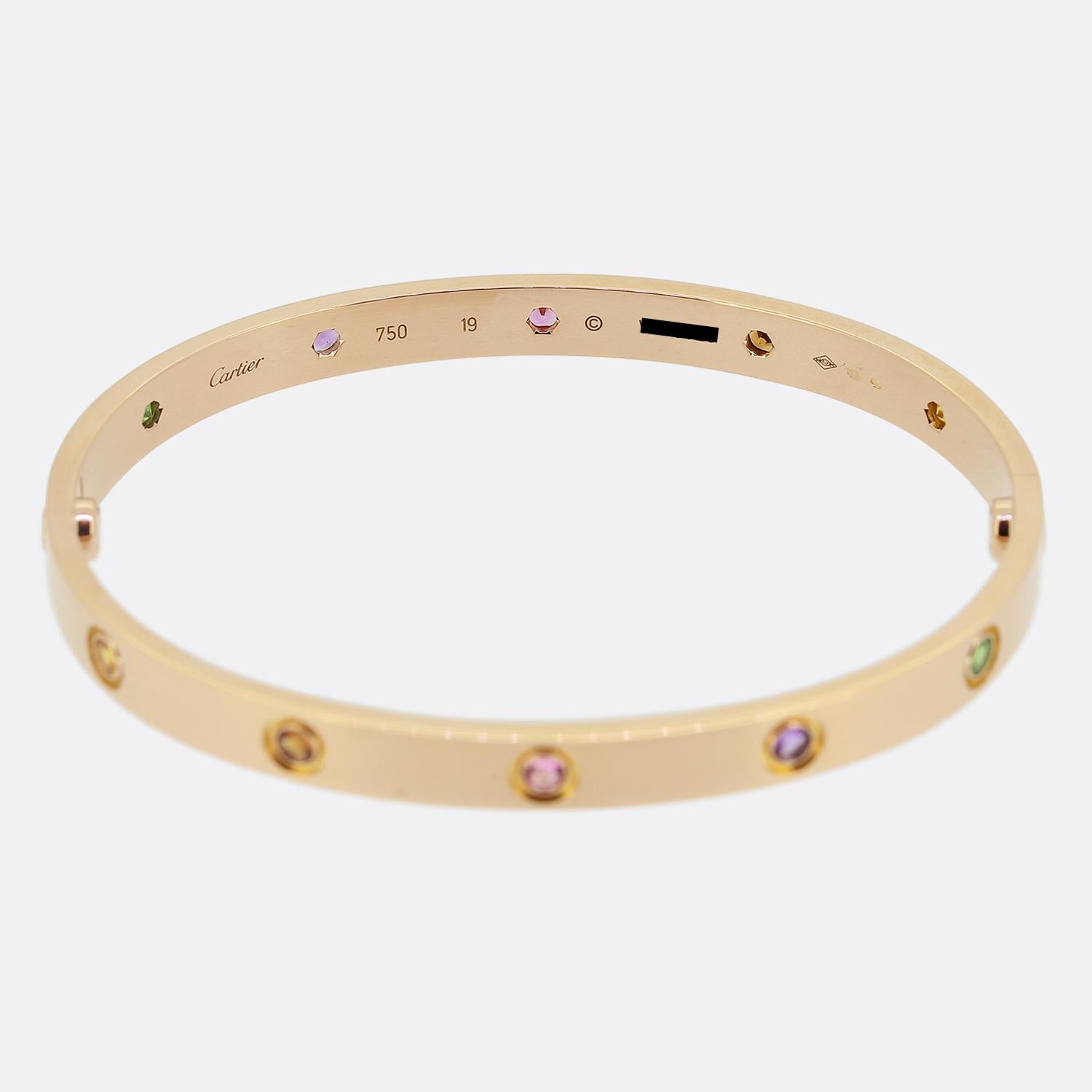 Here we have an 18ct rose gold bangle from the world renowned luxury jewellery house of Cartier. This bangle forms part of the LOVE collection and features ten coloured gemstones alongside the iconic screw motif including: amethysts, rose and yellow