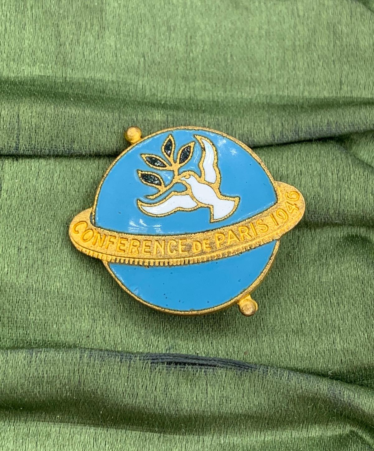 This is a very rare Cartier Enamel Pin Brooch Medal from the Conference De Paris 1946.  The brooch is signed Cartier on the reverse and is from the Paris Peace Conference which has held at the end of WWII in Paris.  The wonderful brooch has an