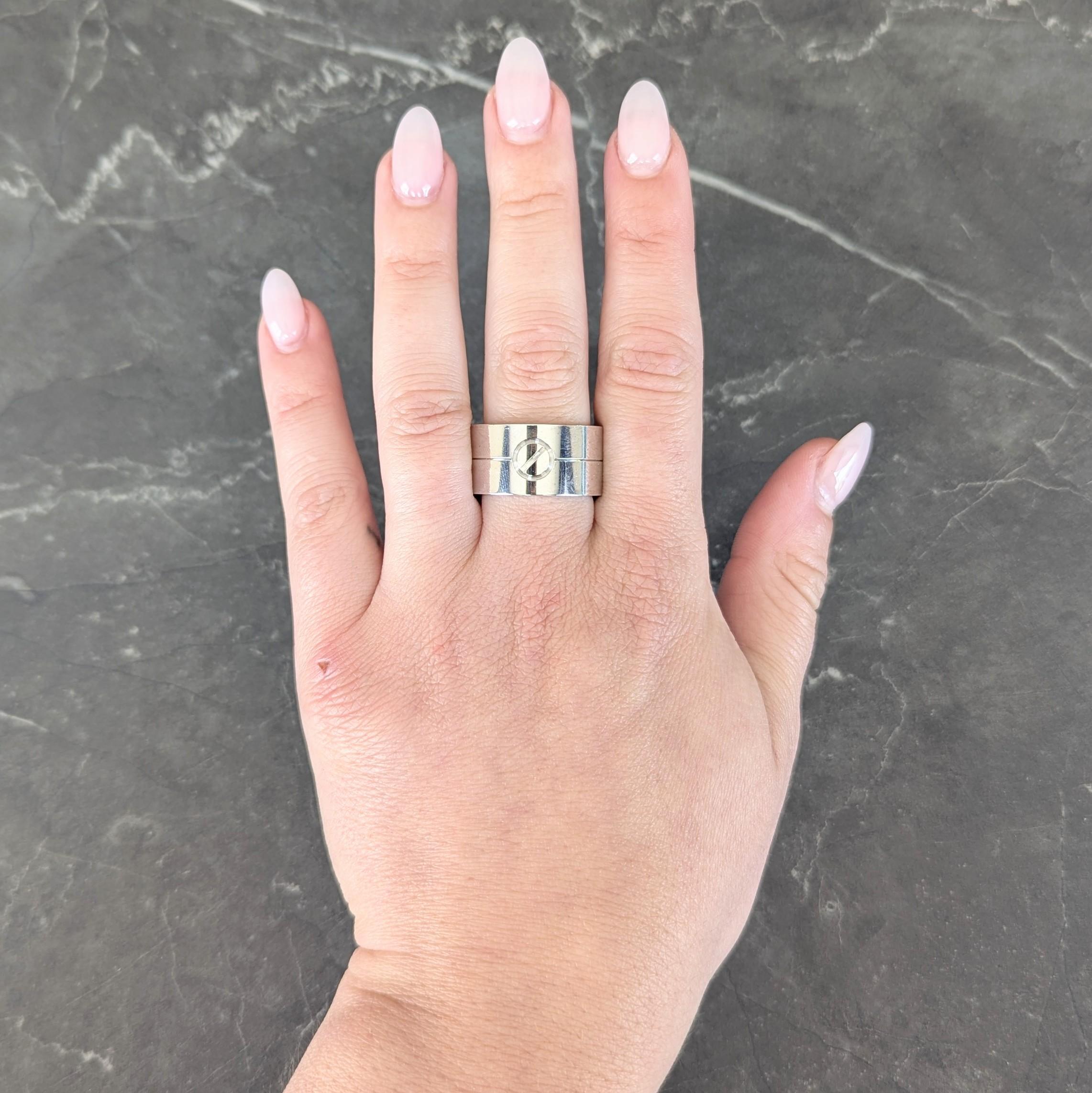 Designed as a wide band with grooved screw-head motif
Bisected by grooved line fully around
With high polish finish
Stamped for 18 karat gold
Numbered and fully signed for Cartier
Circa: 2000s; from the Cartier Love Collection
Ring Size: 10 -