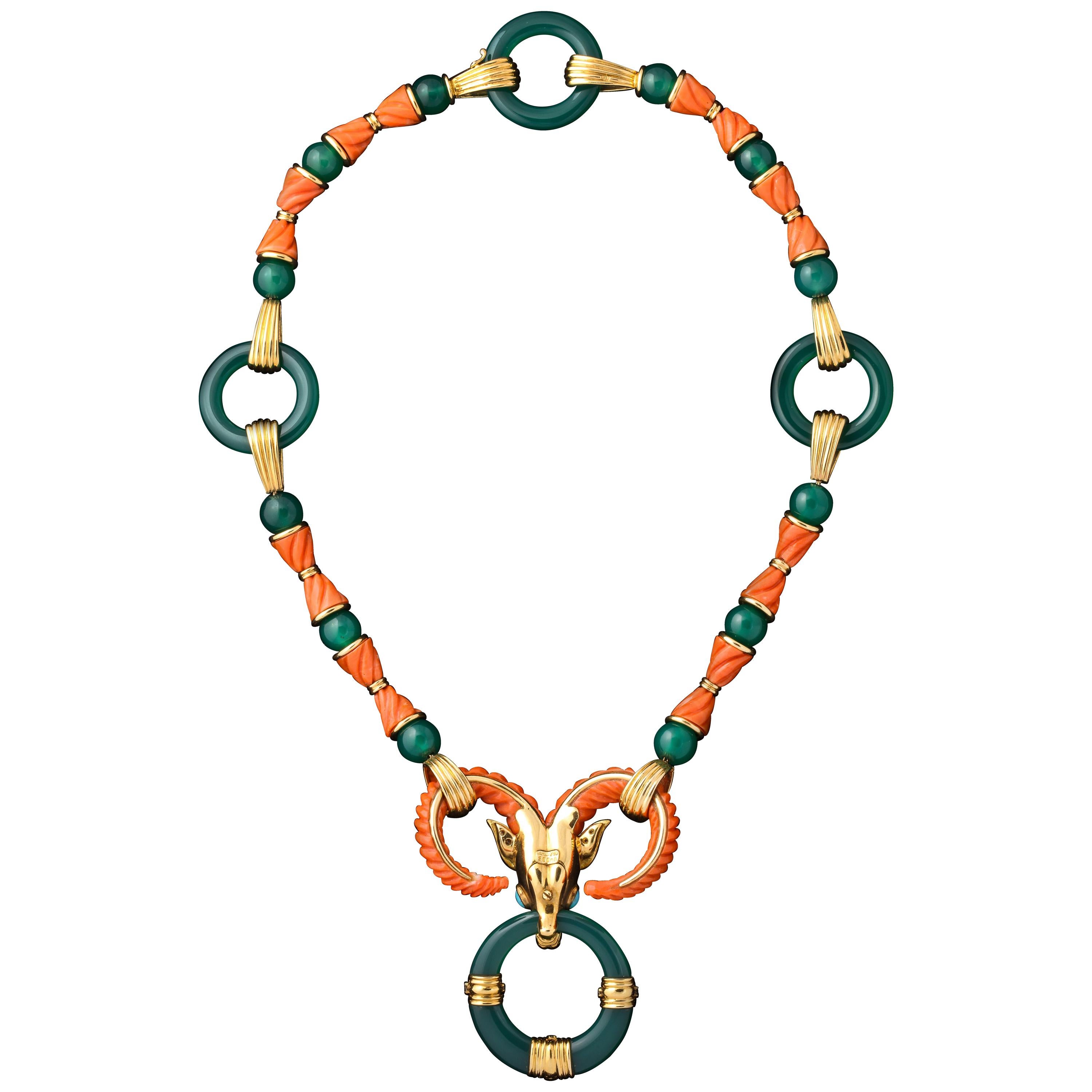 An articulate Cartier necklace with coral and chyroprase depicting an ox. The ox is adorned with brilliant diamonds, and cabochon turquoise for its eyes.