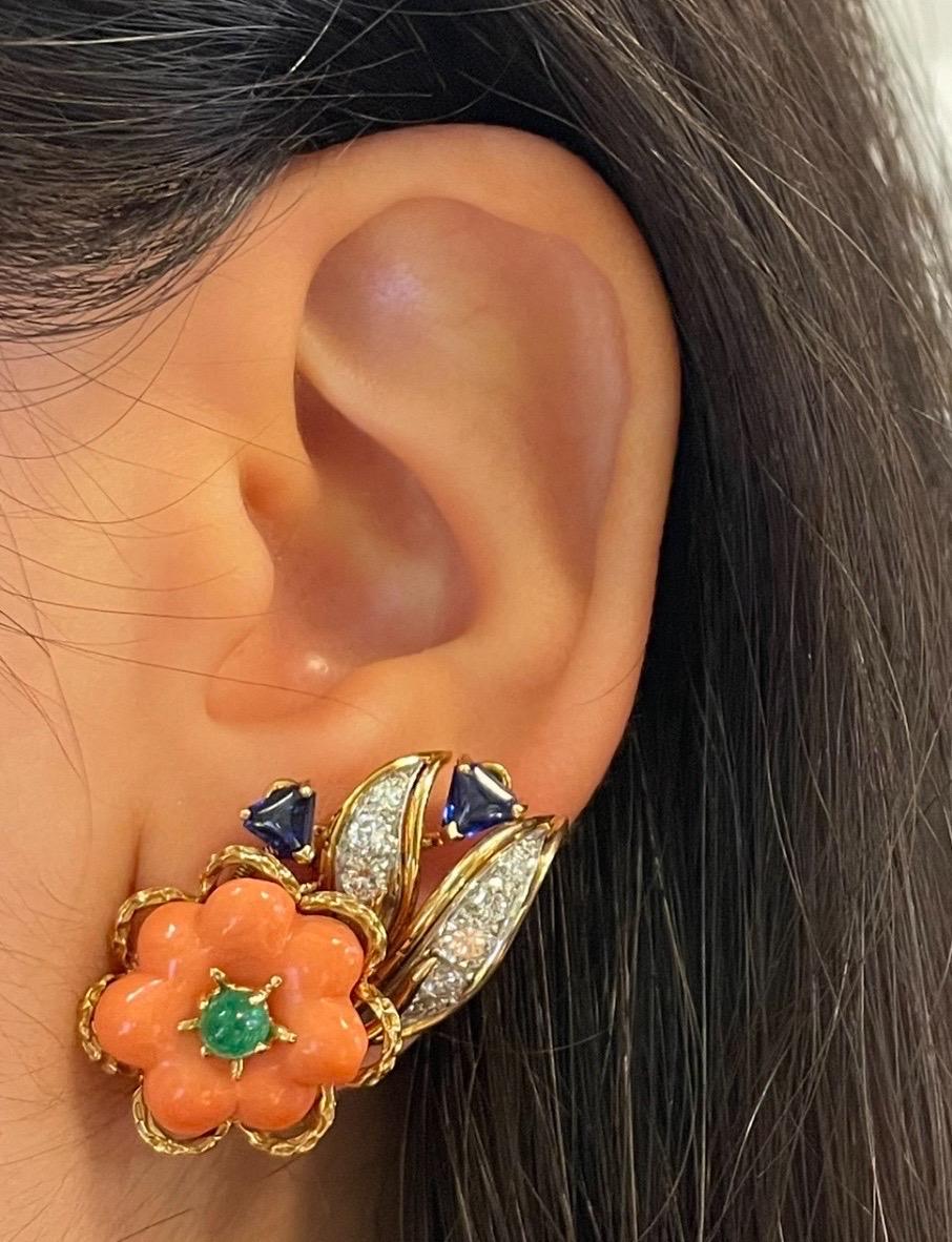 Cartier Coral and Sapphire Earrings

A pair of floral motif earrings featuring a cabochon emerald at the center of coral flowers, accented with diamonds and triangle-cut sapphires as the leaves.

Signed: Cartier and Numbered 
Back type: Clip-on