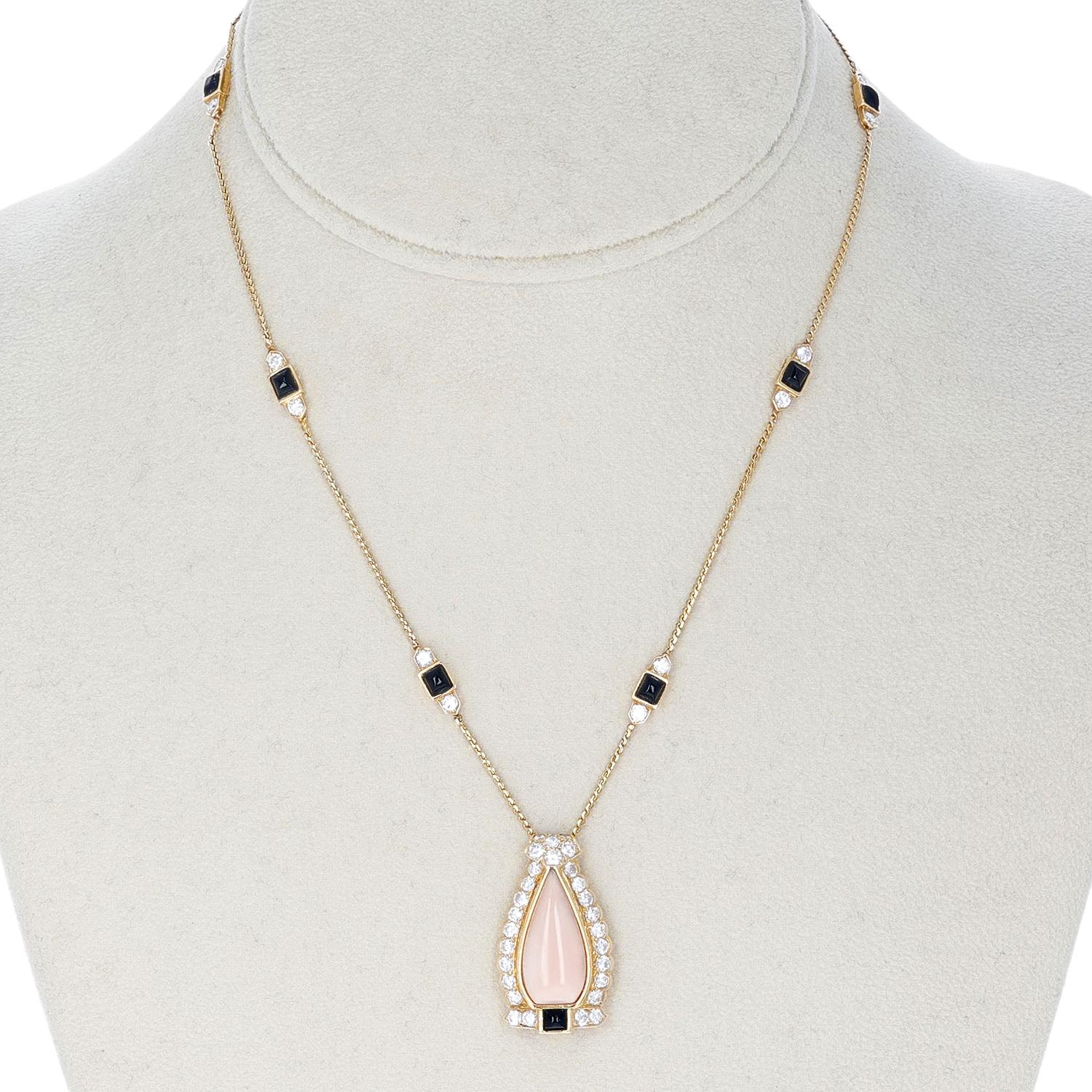 Cartier Coral, Onyx, and Diamond Necklace made in 18 Karat Yellow Gold. The total length of the necklace is 17 inches. The length of the pendant is 1 1/8 inches. The total weight is 13.77 grams. 