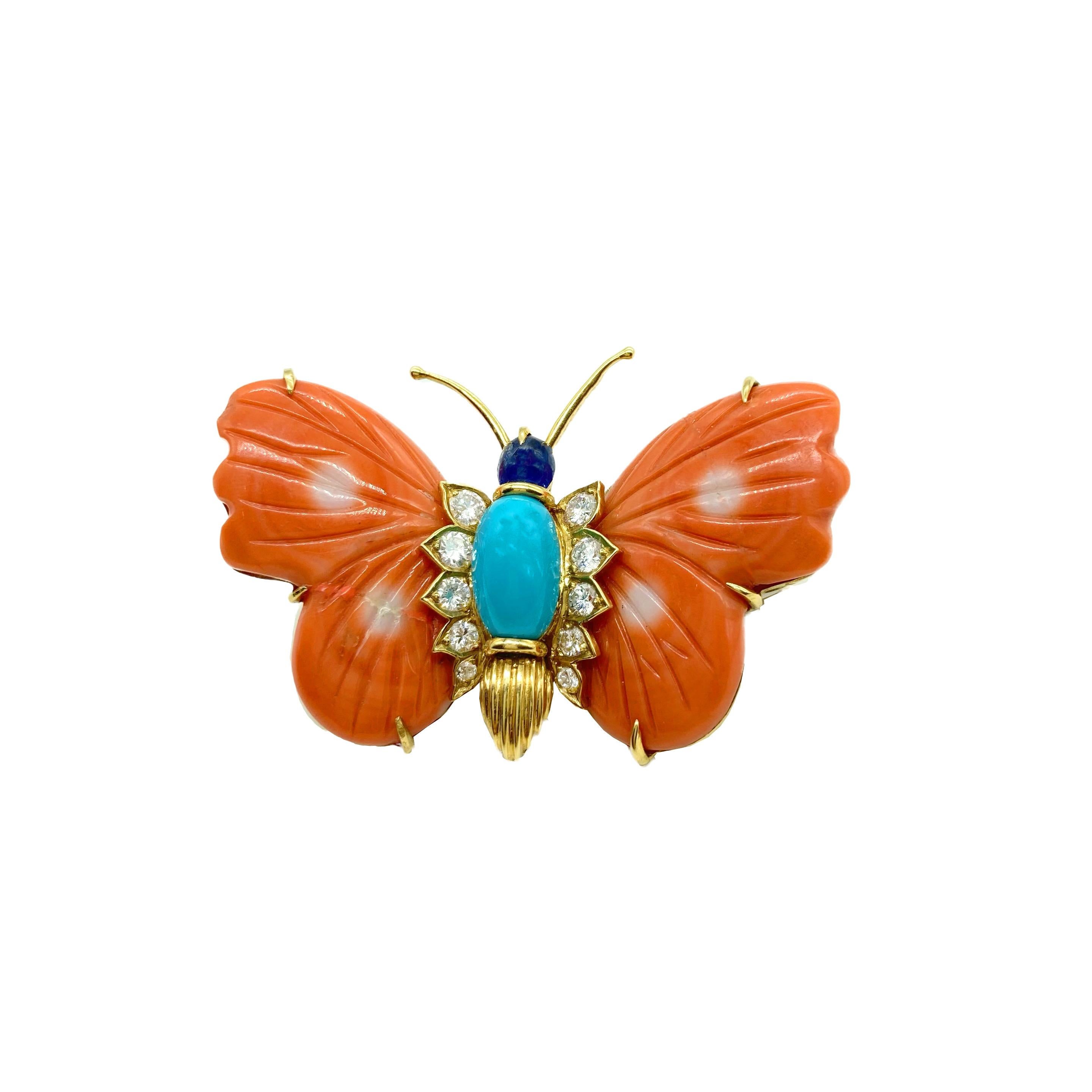 A beautiful vintage Cartier butterfly brooch in 18 karat yellow gold with diamonds, coral, turquoise and cabochon blue sapphire. 
