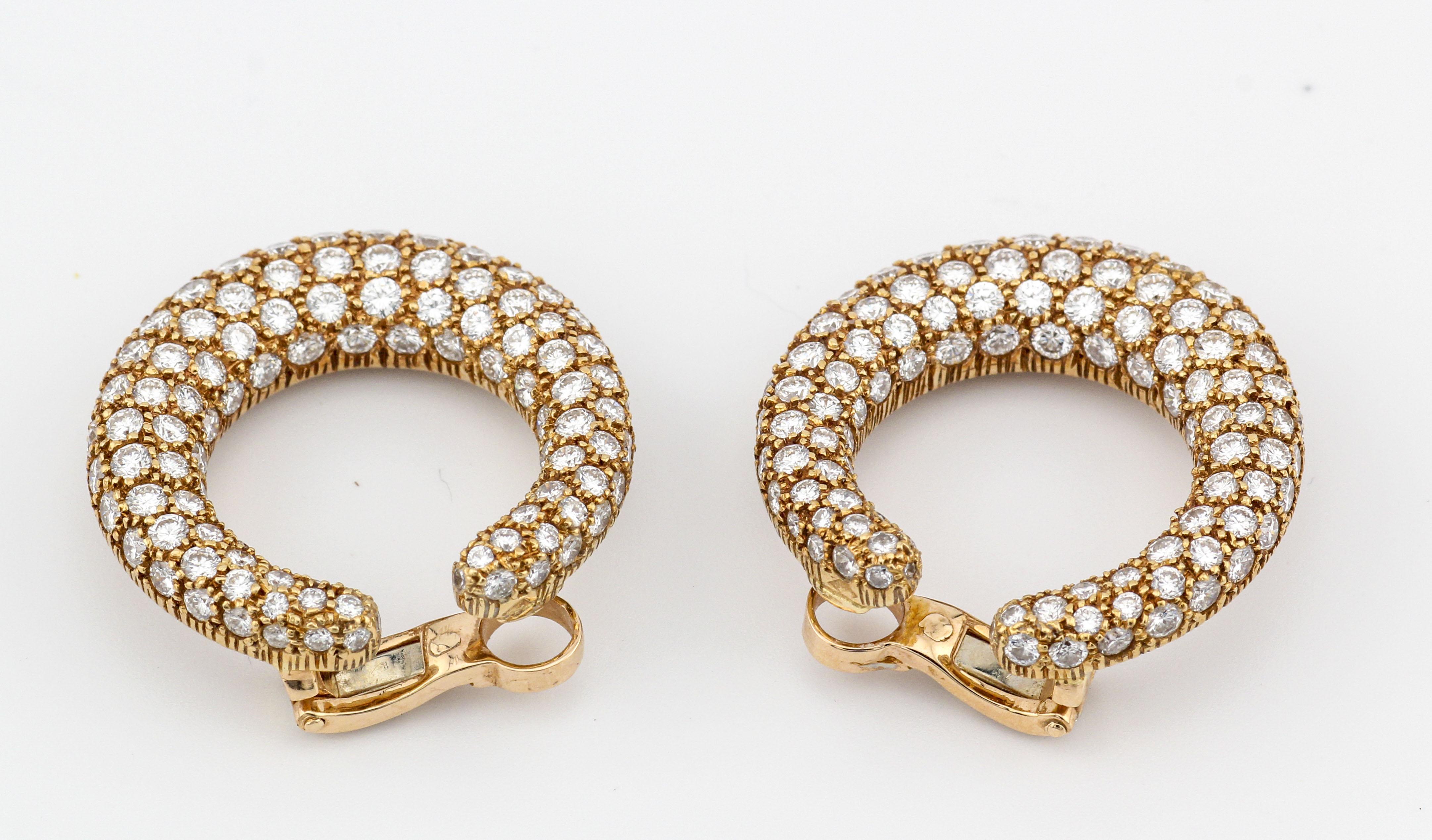 The Cartier Creole Pave Diamond 18K Yellow Gold Hoop Earrings are a dazzling and exquisite example of Cartier's commitment to timeless elegance and superior craftsmanship. These earrings epitomize luxury, combining the radiant warmth of 18K yellow