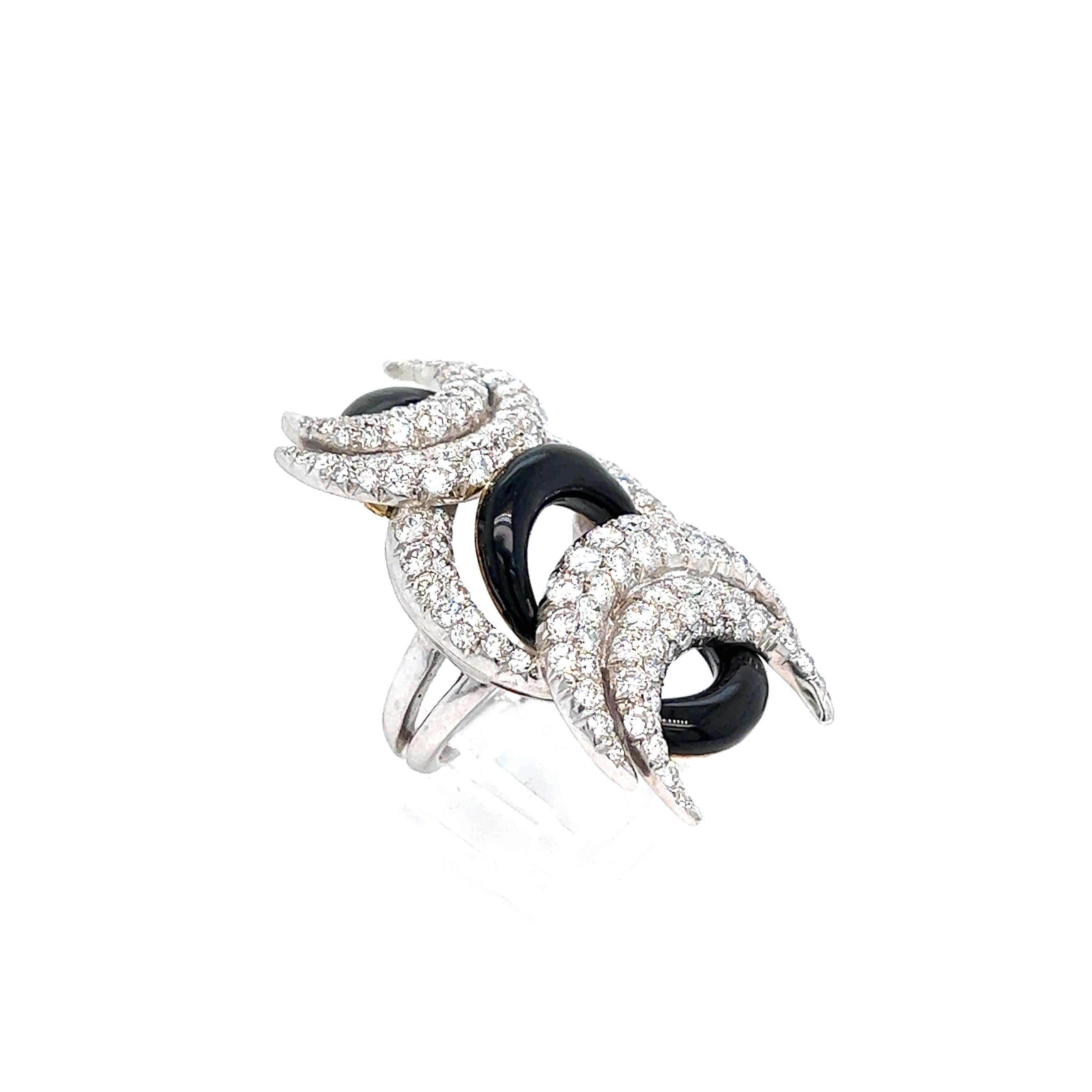 Cartier crescent moons diamond black onyx ring

18 karat white gold and platinum, featuring a crescent moon design; five of the eight moons are made out of diamonds weighing approximately 3.5 carats, while the remaining three are made out of black