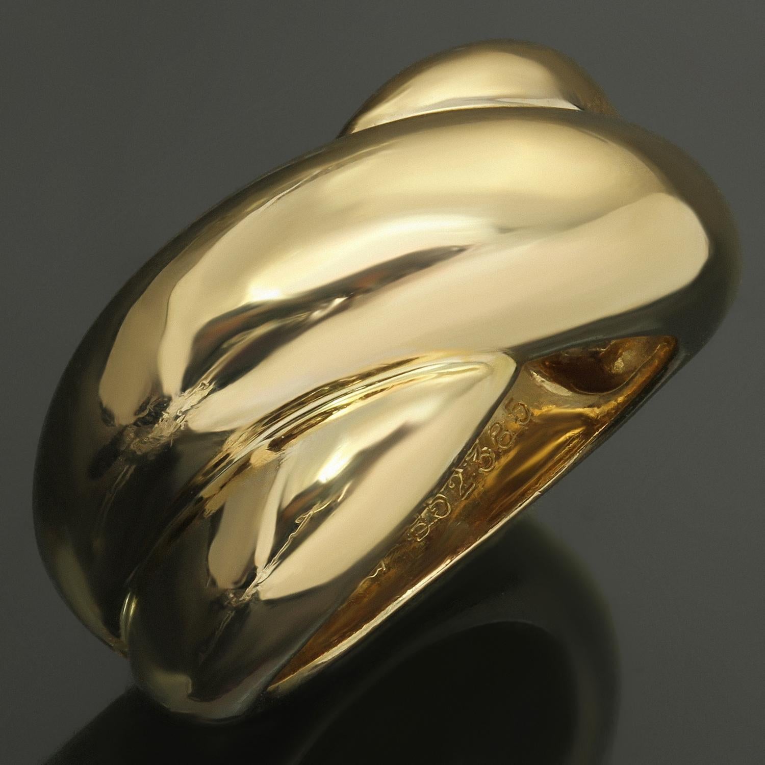This iconic Cartier ring features the classic crossover design crafted in 18k yellow go.d Made in France circa 1992. The ring size is 5.25 - EU 50. Non-resizable. 
