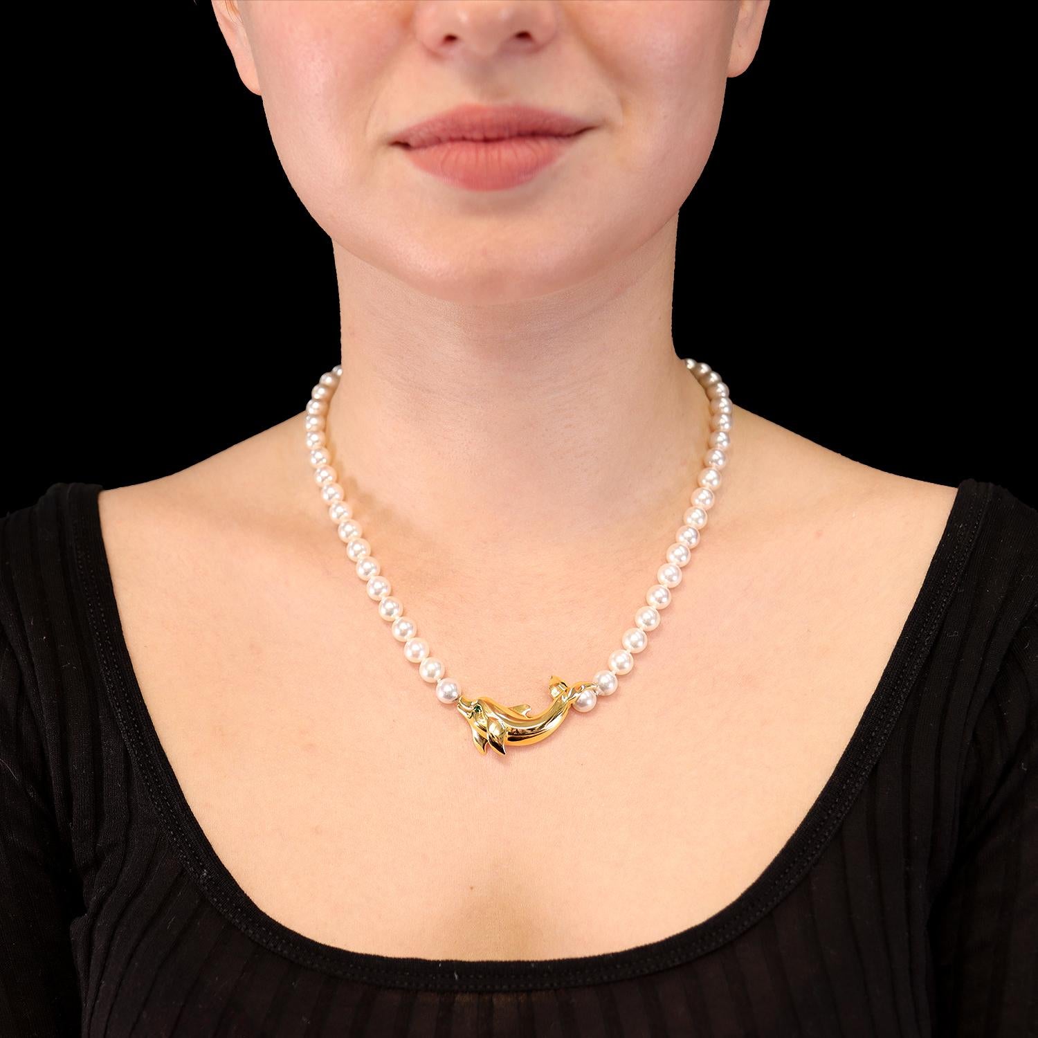 Cartier Cultured Akoya Pearl 'DOLPHIN' Necklace
The 18-karat yellow gold dolphin with a circular-cut tsavorite garnet eye, on a strand of 7.0 mm cultured pearls and a double-C clasp, signed Cartier, numbered no. 750644

43.5cm long

Dolphin and
