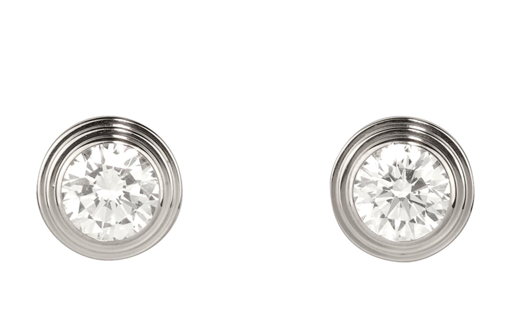 Cartier d'Amour Diamond Earrings 
Style:  Bezel
Ref. number:  B8041400
Metal:  18kt White Gold
Size:  Medium
Measurements:  5.03 MM width - 2.8 MM thickness
TCW:  0.26 tcw
Main Diamond:  2 Round Brilliant Diamond 0.26 tcw
Color & Clarity:  F - G,