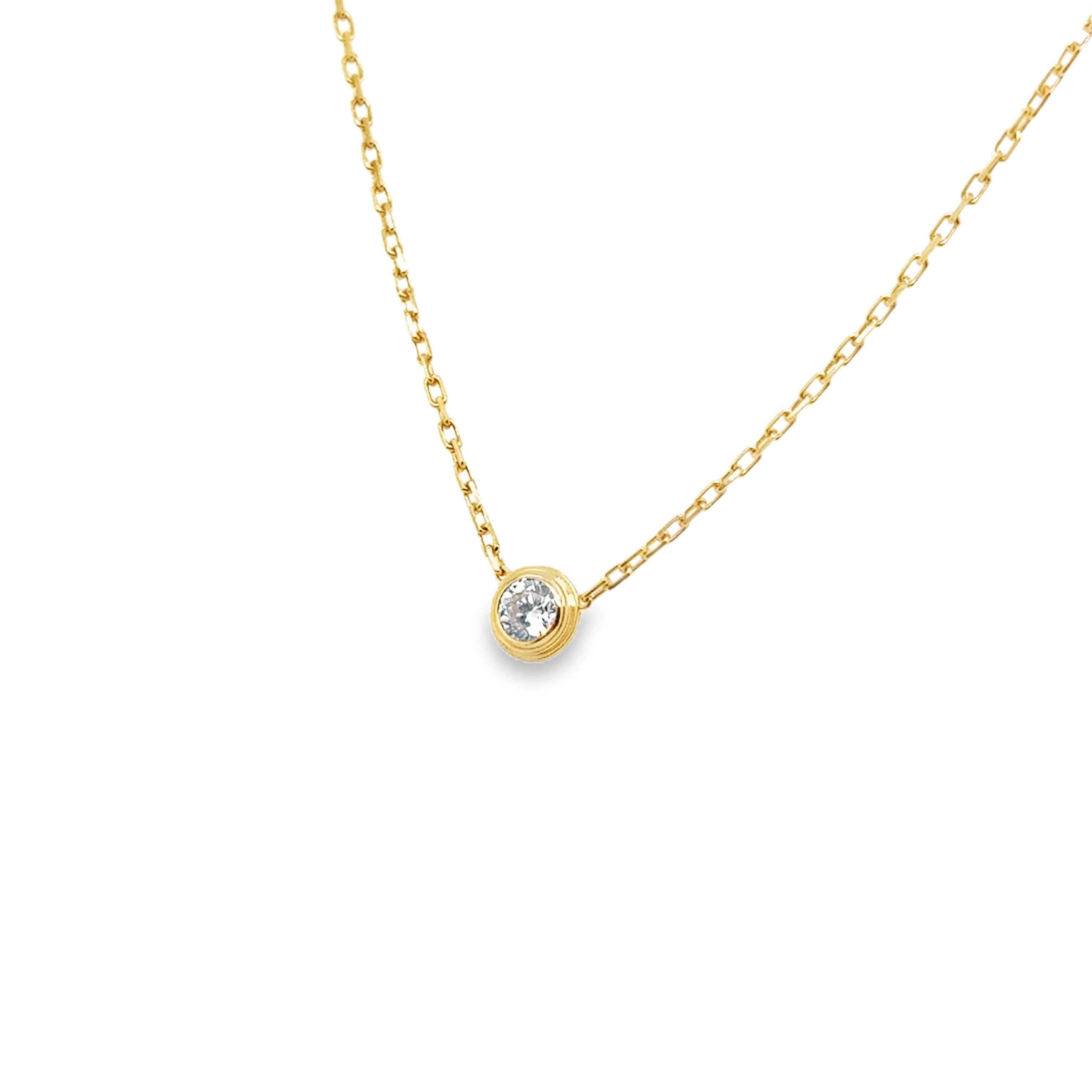 Cartier d'Amour necklace a simple, yet elegant design. Crafted in 18k yellow gold this is the large model. The necklace is set with a round brilliant-cut diamond totaling 0.18 carat. The diamond is bezel set  showing a layered design. The pendant is