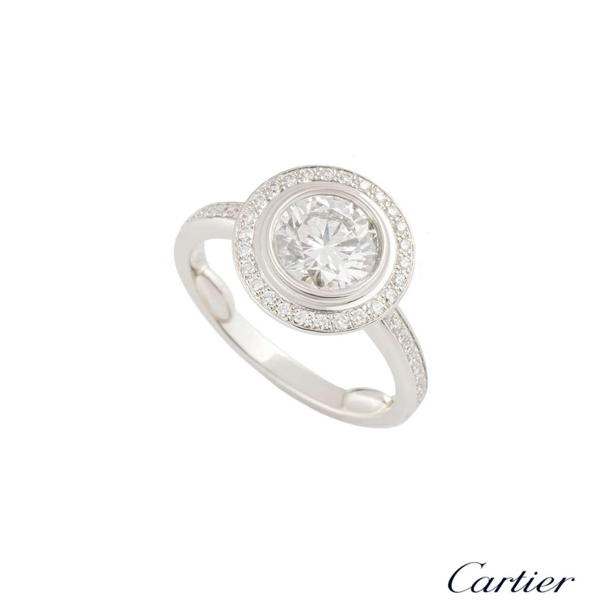 A luxurious platinum Cartier diamond engagement ring from the Cartier D'Amour collection. The ring comprises of a round brilliant cut diamond in a rubover setting with a total weight of 1.03ct, F colour and VVS1 clarity. Complementing the centre