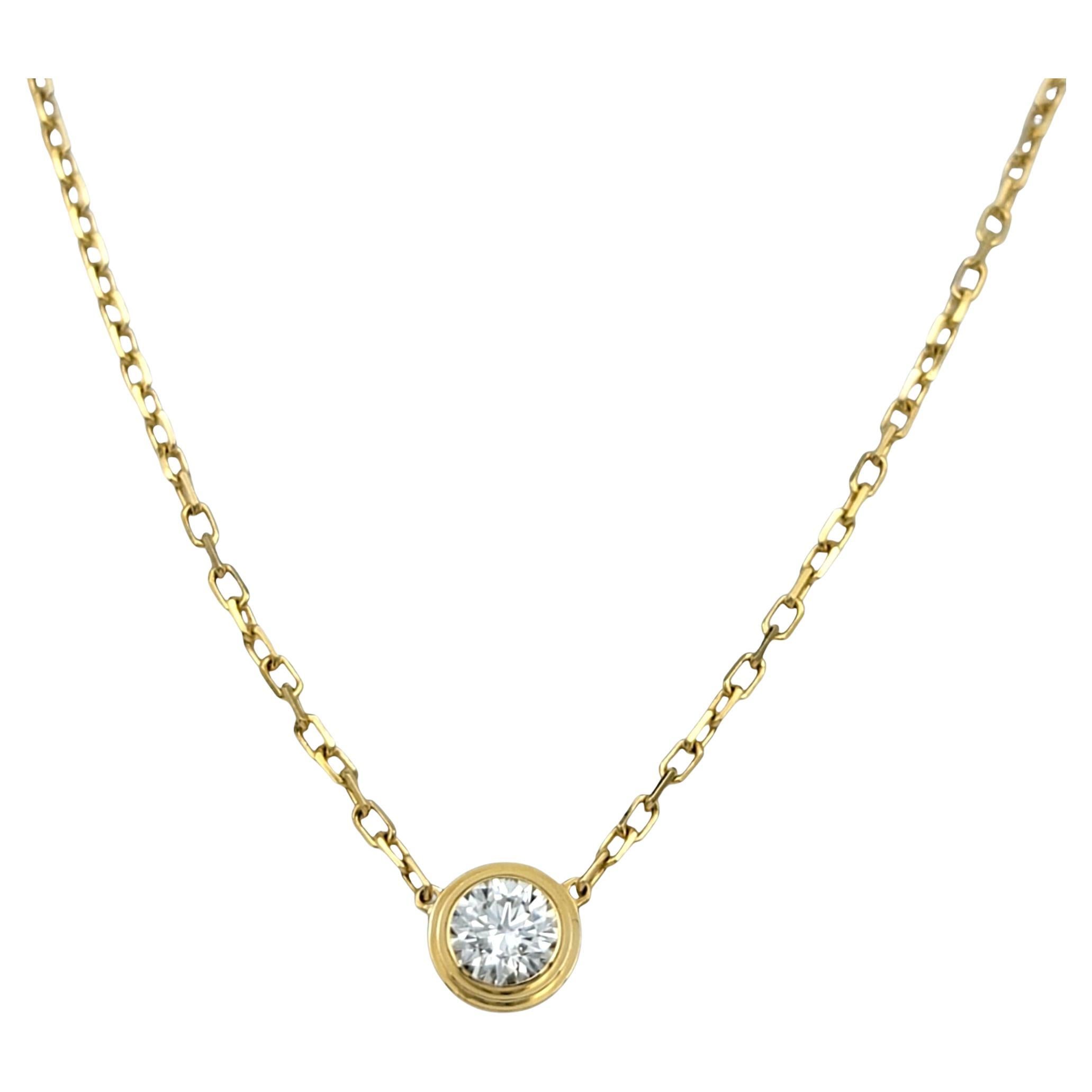 This authentic Cartier D’Amour necklace (large model) is crafted in 18 karat yellow gold and features a bezel-set .18 carat round brilliant cut diamond at its center. The clean and refined design places focus on the singular diamond, which is framed