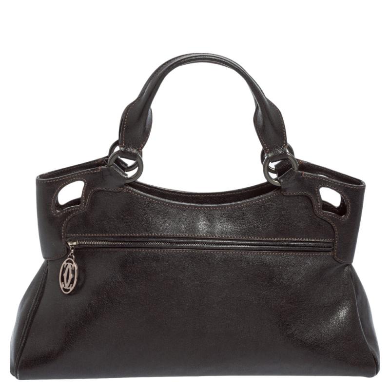 This Cartier beauty arrives in a gorgeous shape and design. It has a leather body with the logo detailed on the exterior and is held by two handles. The zipper secures the fabric interior and overall, the Marcello De Cartier bag looks ready to lift