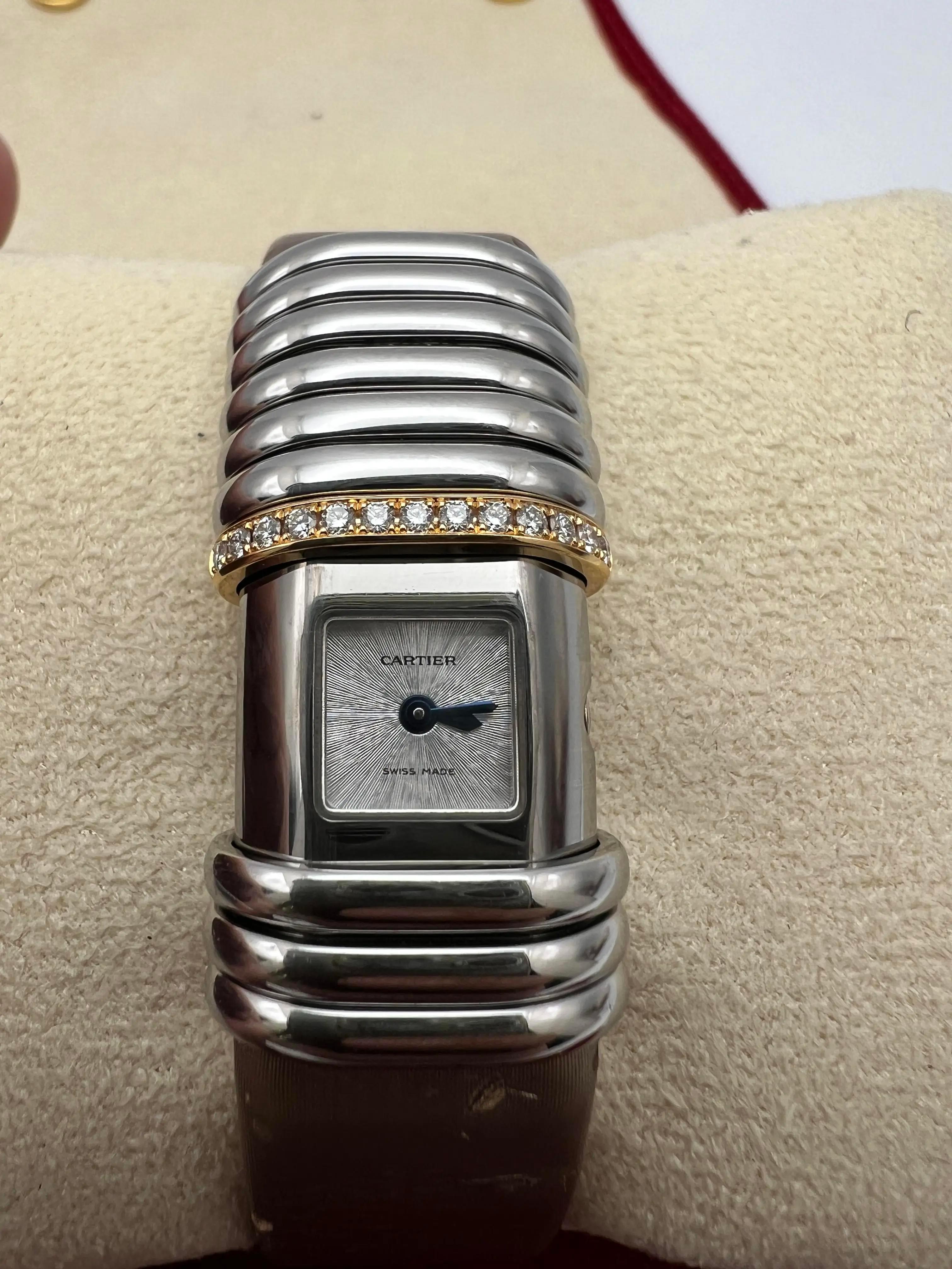 Cartier Declaration Quartz Titanium and 18K Rose Gold with diamond watch on. leather strap with deployant buckle. The watch is a beautiful combination of jewelry and watch in one. With sliding steel and rose gold with diamond rings up and down the