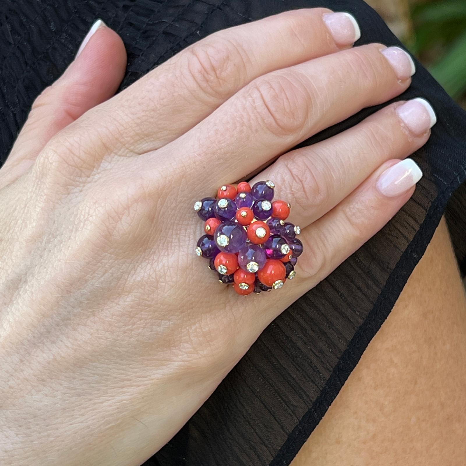 Cartier Delices De Goa cocktail ring handcrafted in 18 karat yellow gold. The colorful ring features amethyst and coral beads set with 14 round brilliant cut diamonds weighing approximately .43 CTW. The diamonds are graded F-G color and VVS-VS