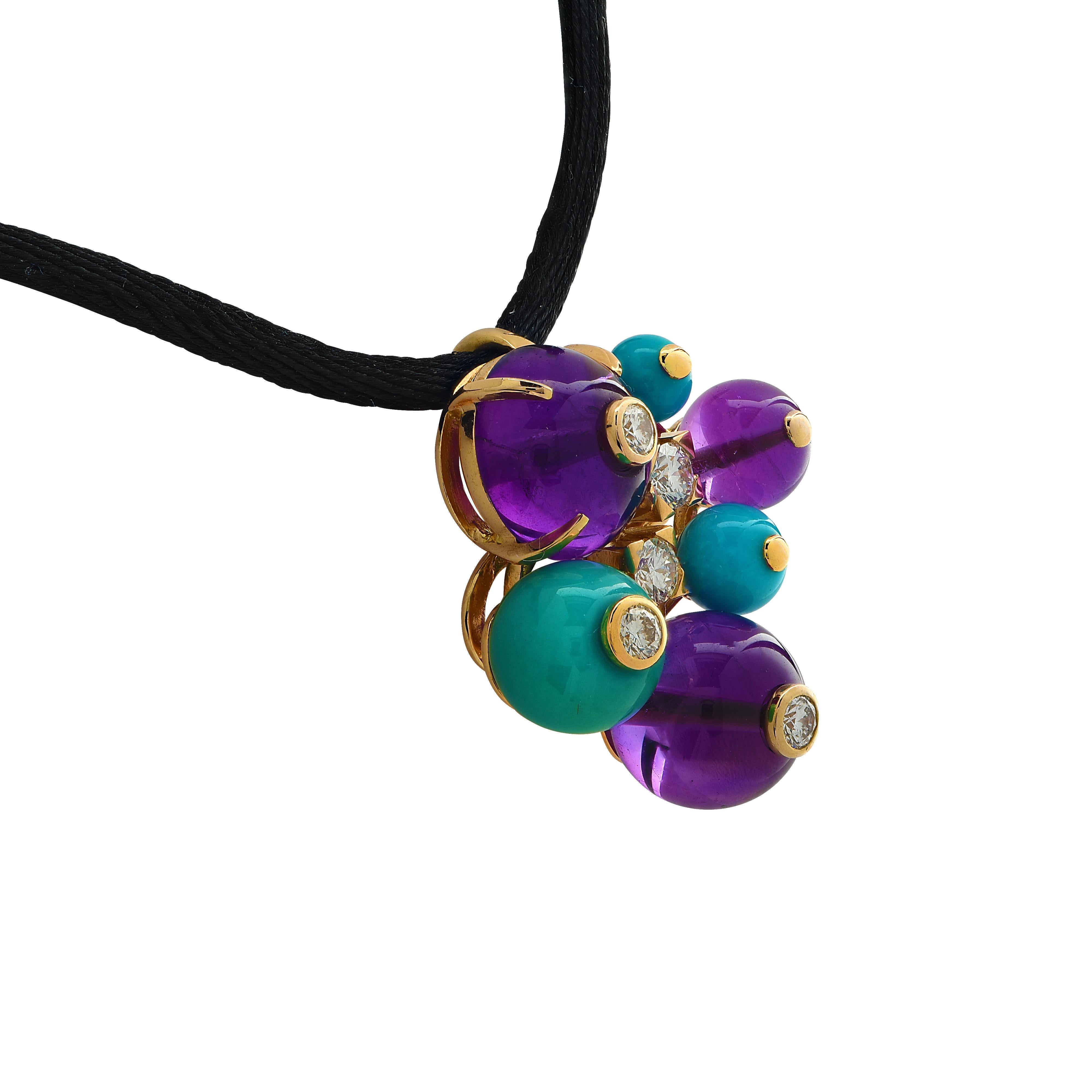 Enchanting Delices De Goa Pendant from the iconic House of Cartier, finely crafted in 18 yellow gold,  featuring a cluster of 3 amethyst beads and three turquoise beads varying in size, adorned with 5 round brilliant cut diamonds weighing