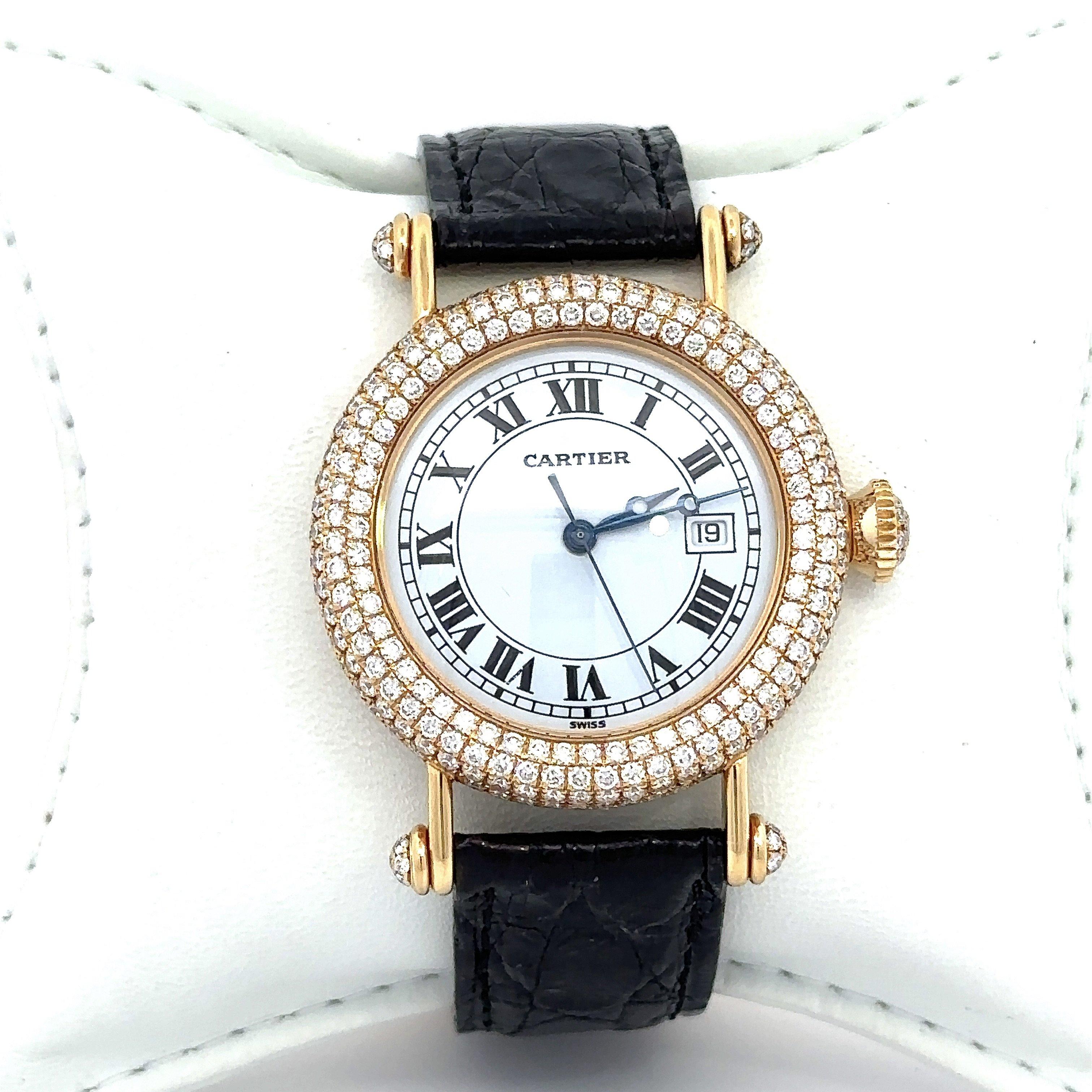 This gorgeous Cartier Diabolo wristwatch is crafted in 18KT Yellow Gold and features a quartz movement. It has an elegant white dial with roman numerals, and a date window. The dial is encircled by sparkling round diamonds, with diamonds also
