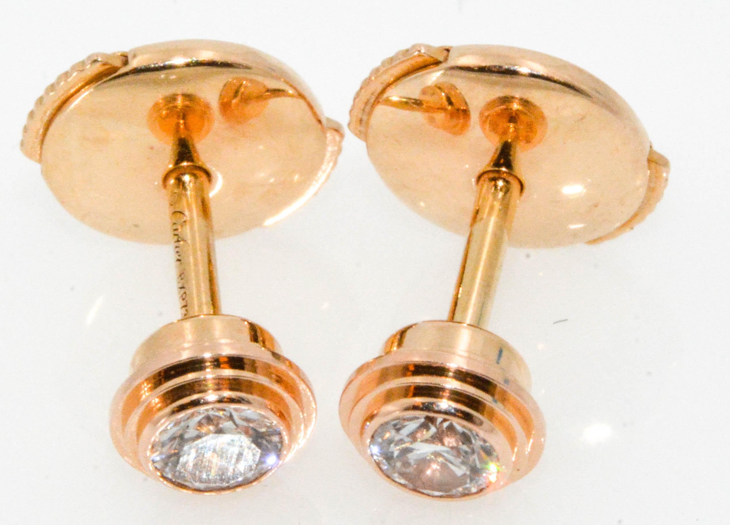 Cartier Diamants Legers diamond stud earrings in 18 karat rose gold. 0.18 ctw round brilliant cut diamonds with F color and VS clarity. Circa 1980.