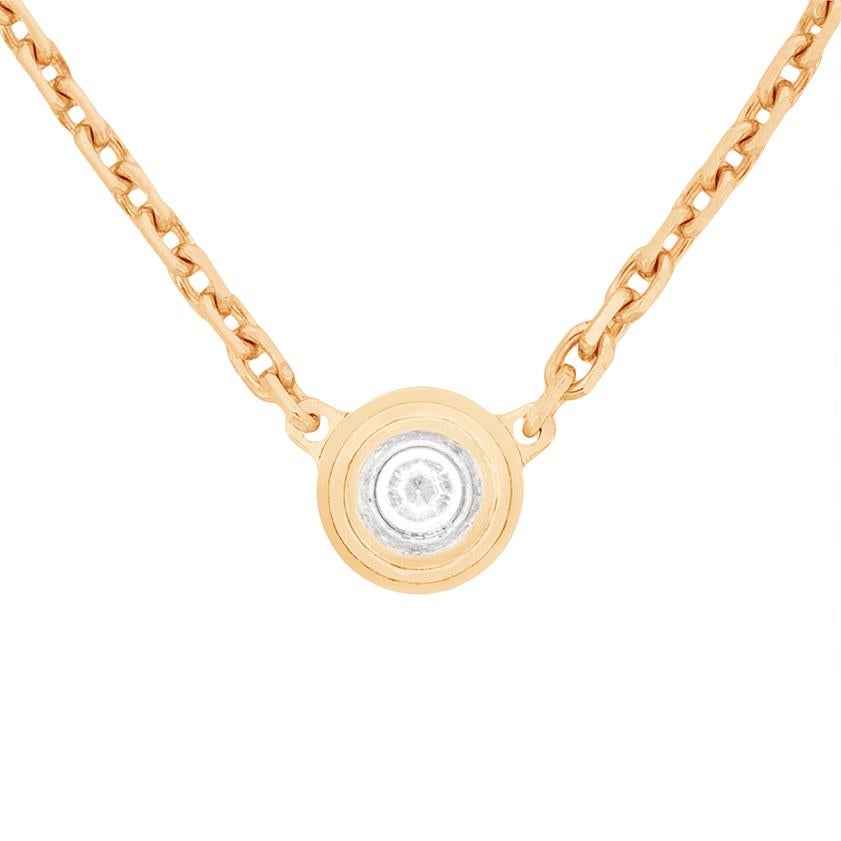 This beautiful necklace by Cartier is their 'Diamants Légers' piece. It features a 0.09 carat round brilliant diamond within a rub over setting. The piece is all in rose, or pink, gold. It is the smaller design and comes with the original Cartier
