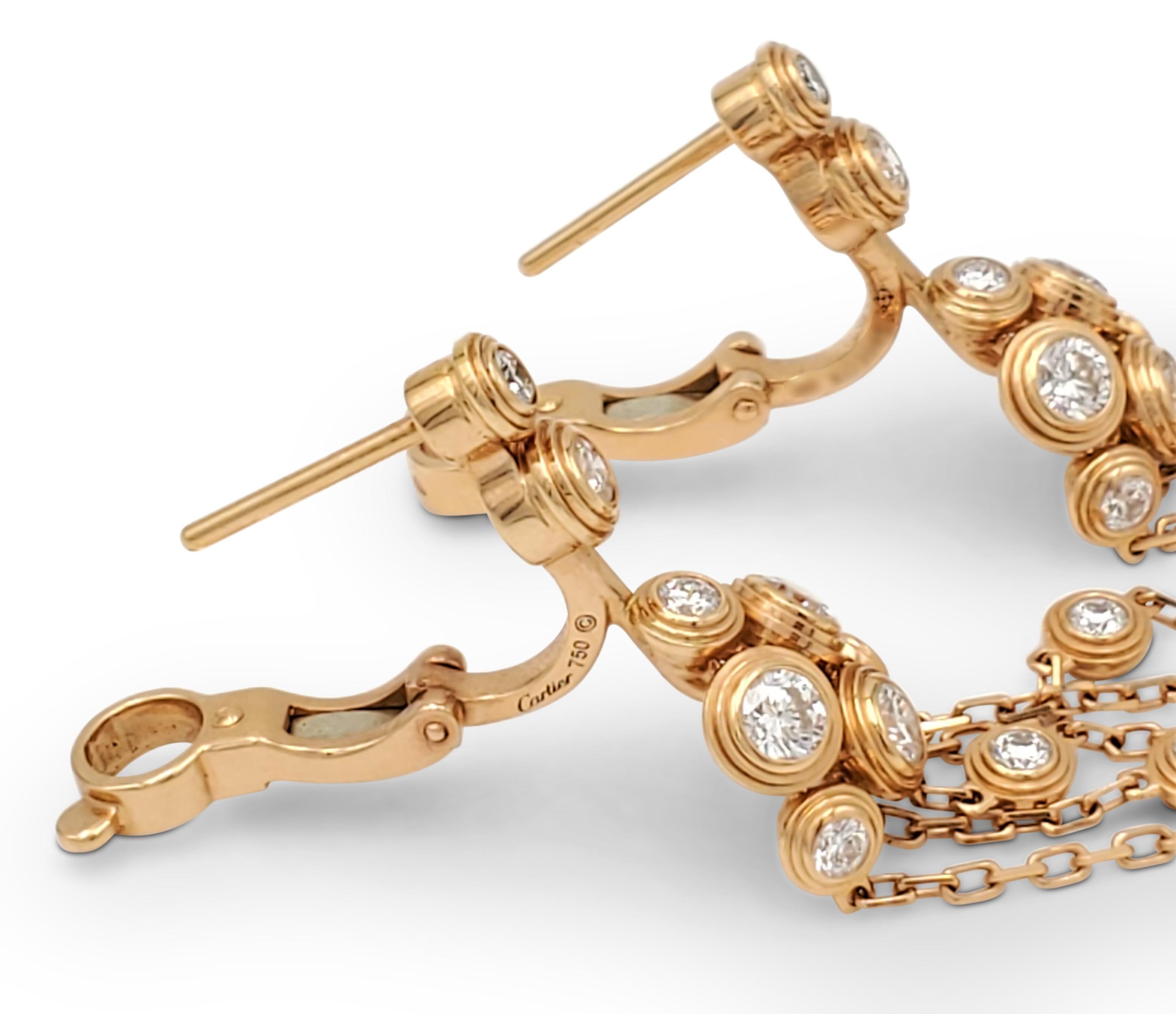 Authentic elegant Cartier 'Diamants Légers' earrings crafted in 18 karat yellow gold feature a series of diamonds set on lightweight gold chains. The earrings are set with high-quality diamonds weighing an estimated 1.45 carats (E-F color, VS